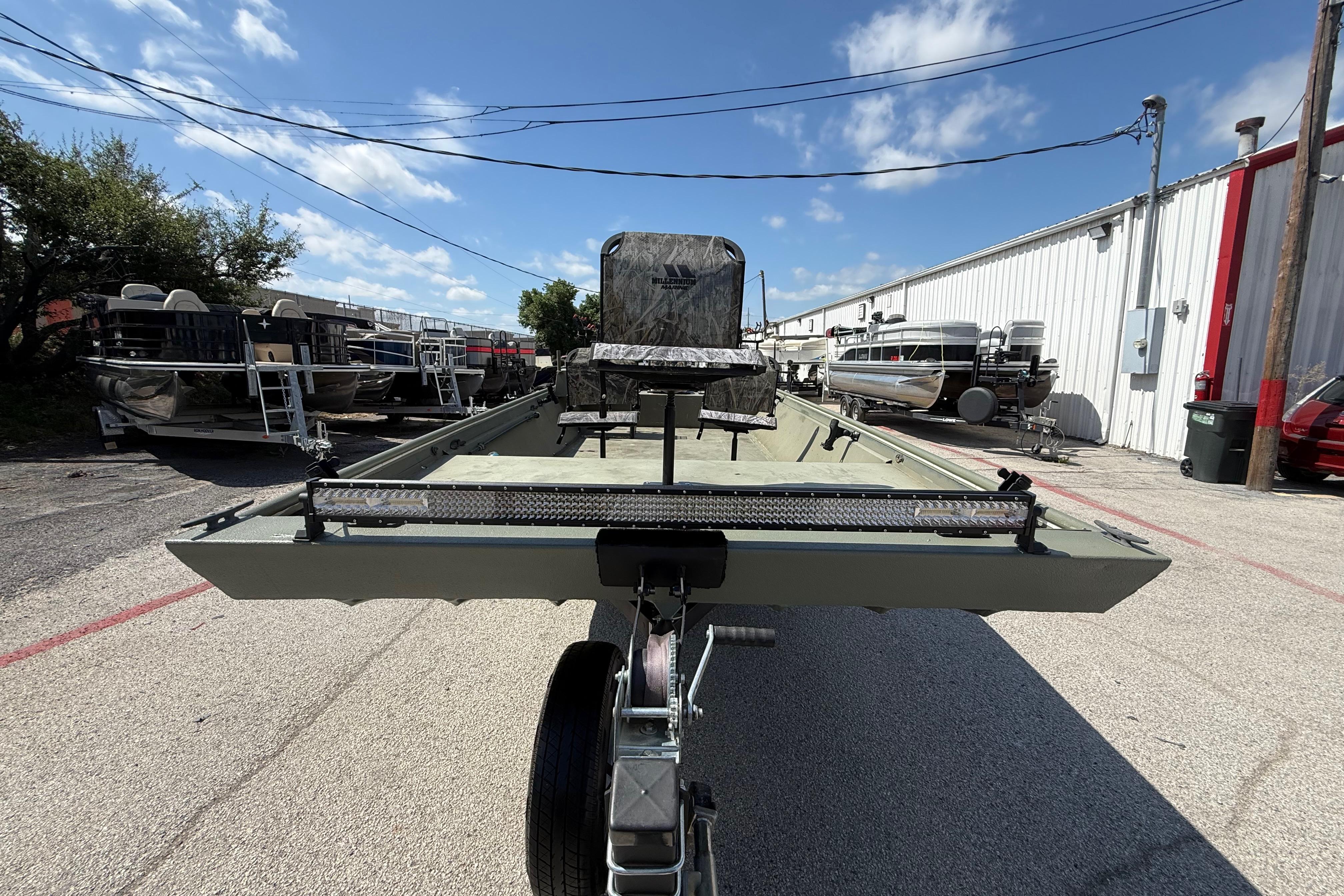 A 2020 Lowe Roughneck 2070 Big River boat on a trailer in an outdoor area.