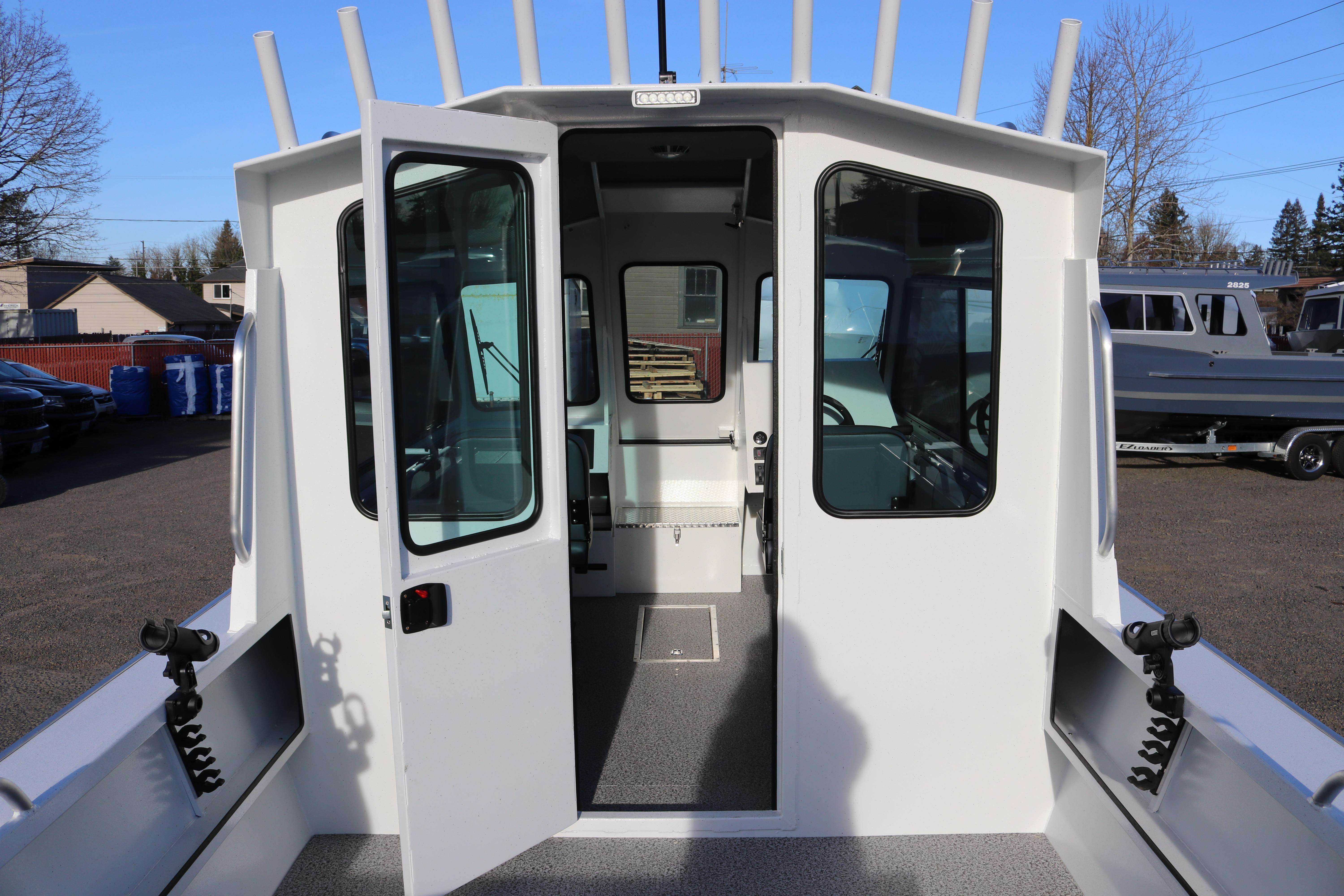 2026 Alumaweld Intruder Outboard 22 boat with open cabin doors, showcasing interior.