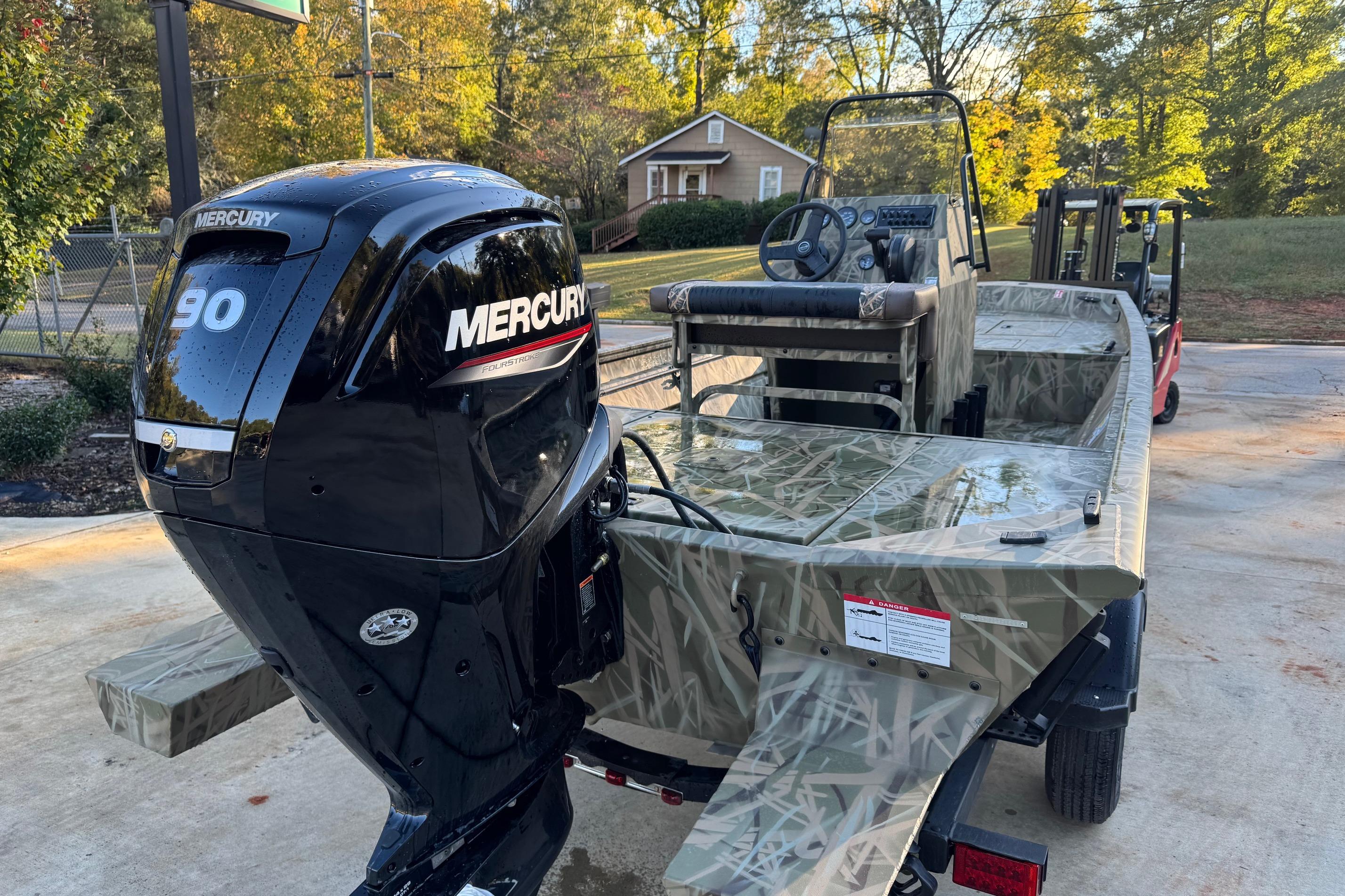 2026 Crestliner 1860 Retriever CC boat with Mercury 90 engine, camo design.