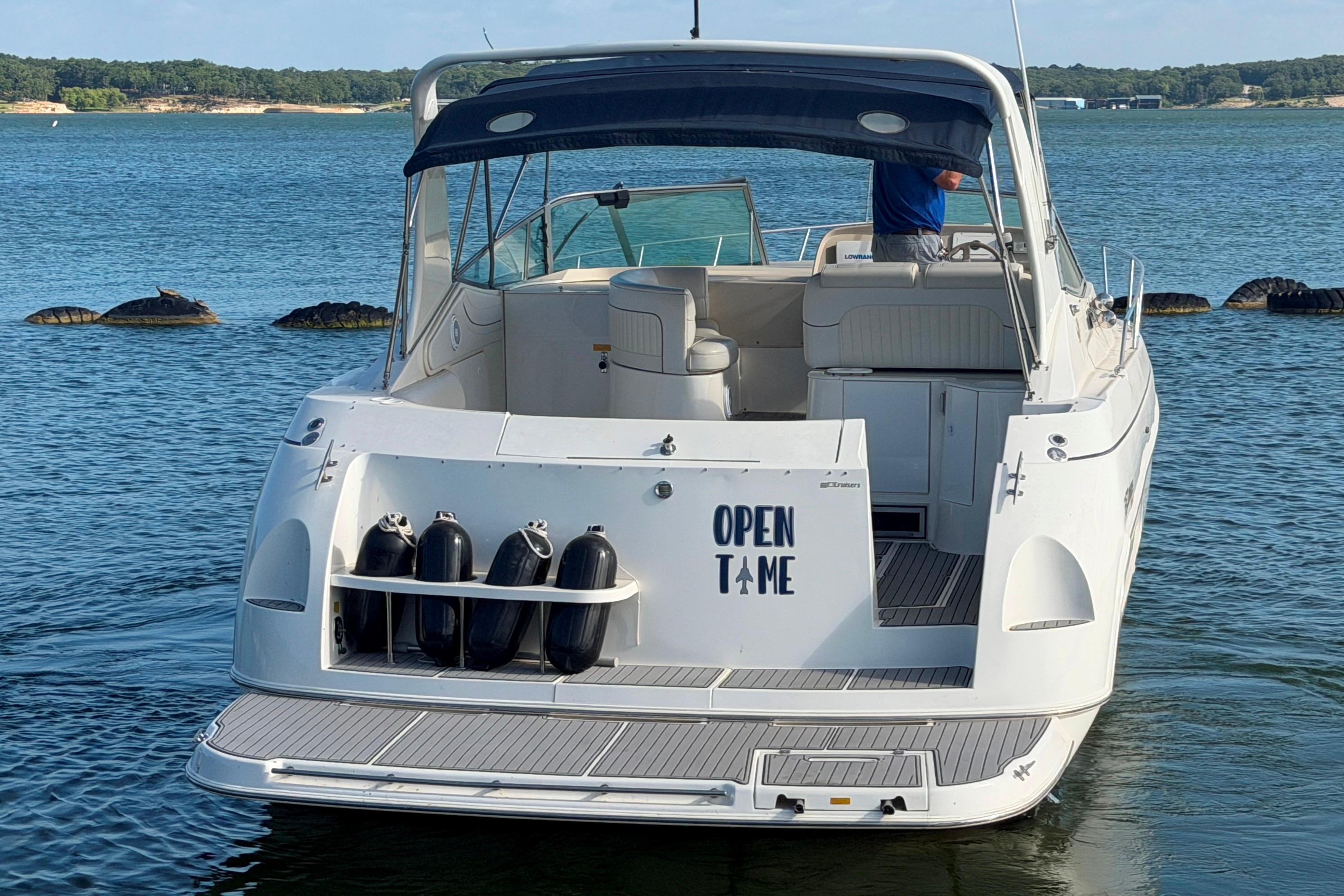 1997 Cruisers 3575 yacht named "Open Time" on a serene lake.