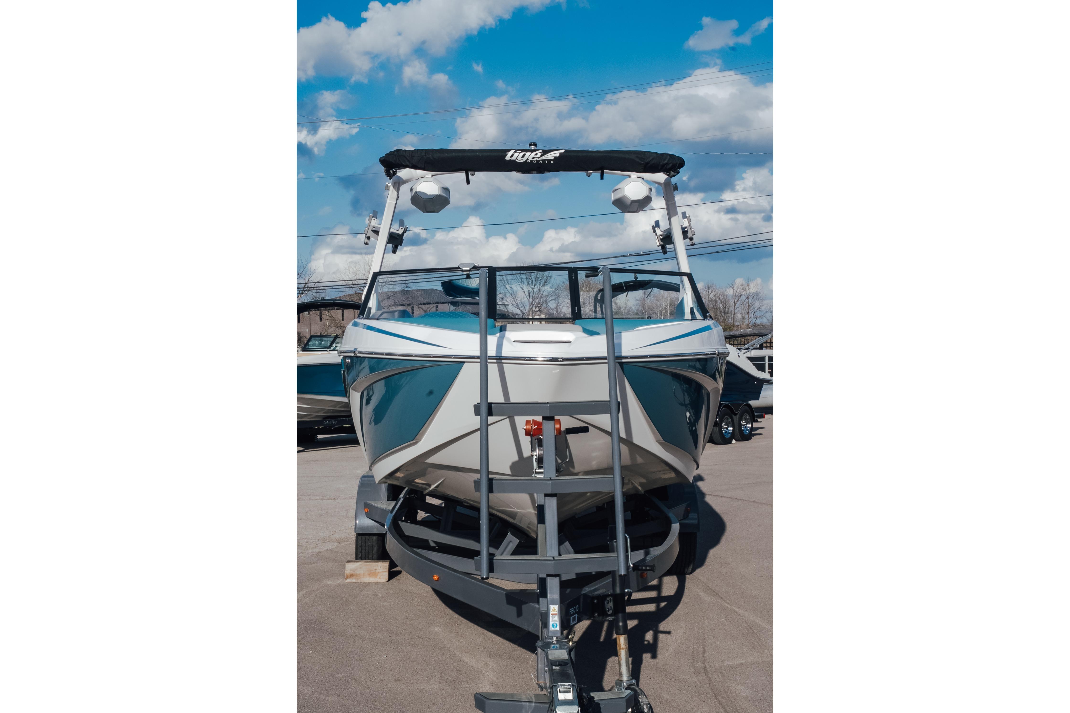 2023 Tigé Z1 boat on trailer under blue sky.