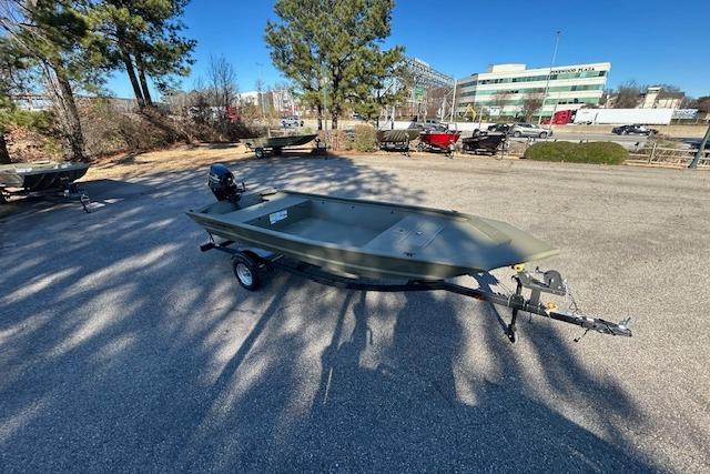 2026 Tracker Grizzly 1648 Utility boat on trailer in parking lot.
