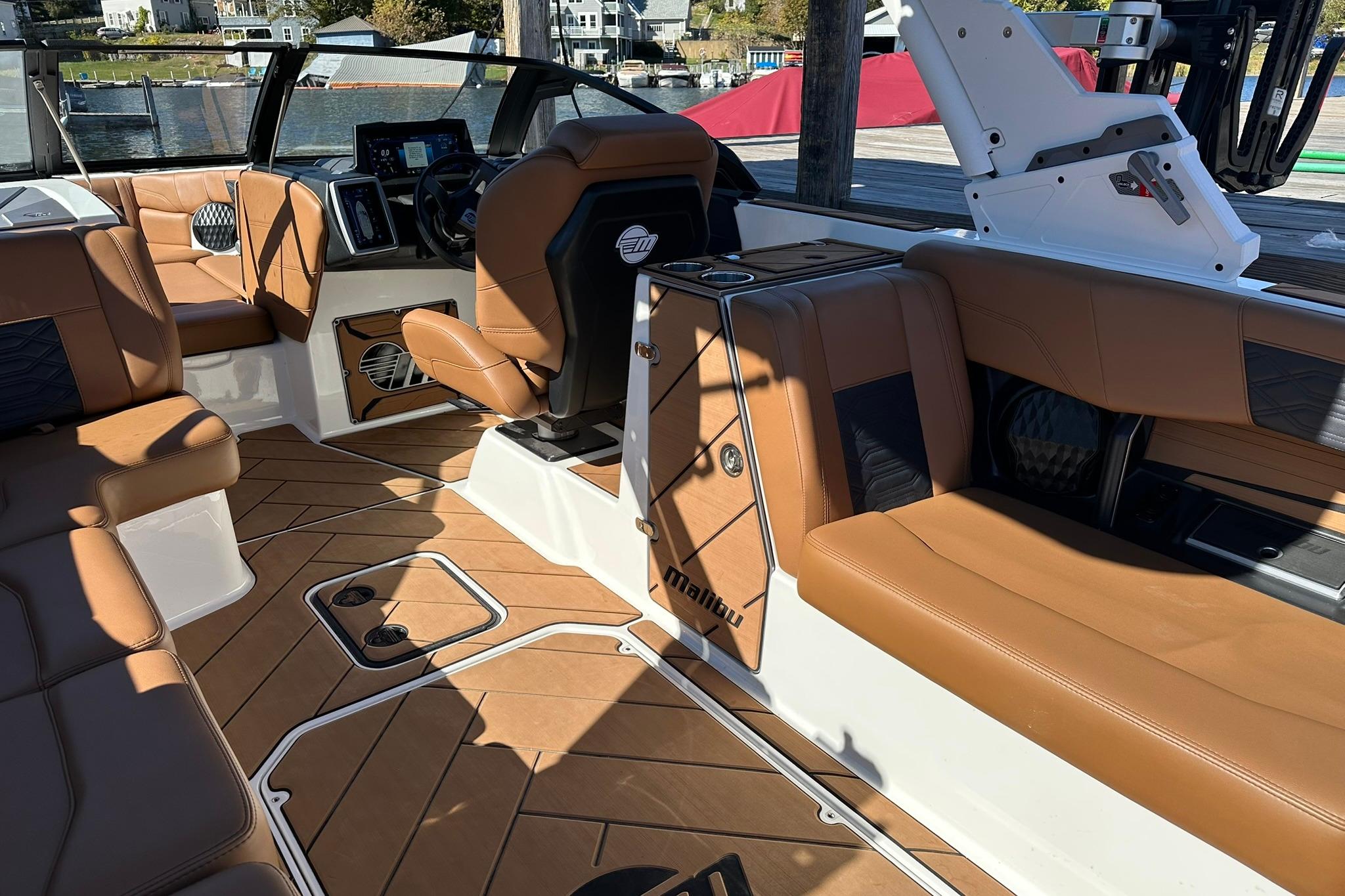 2024 Malibu Wakesetter 25 LSV interior with luxurious tan seating and modern dashboard.