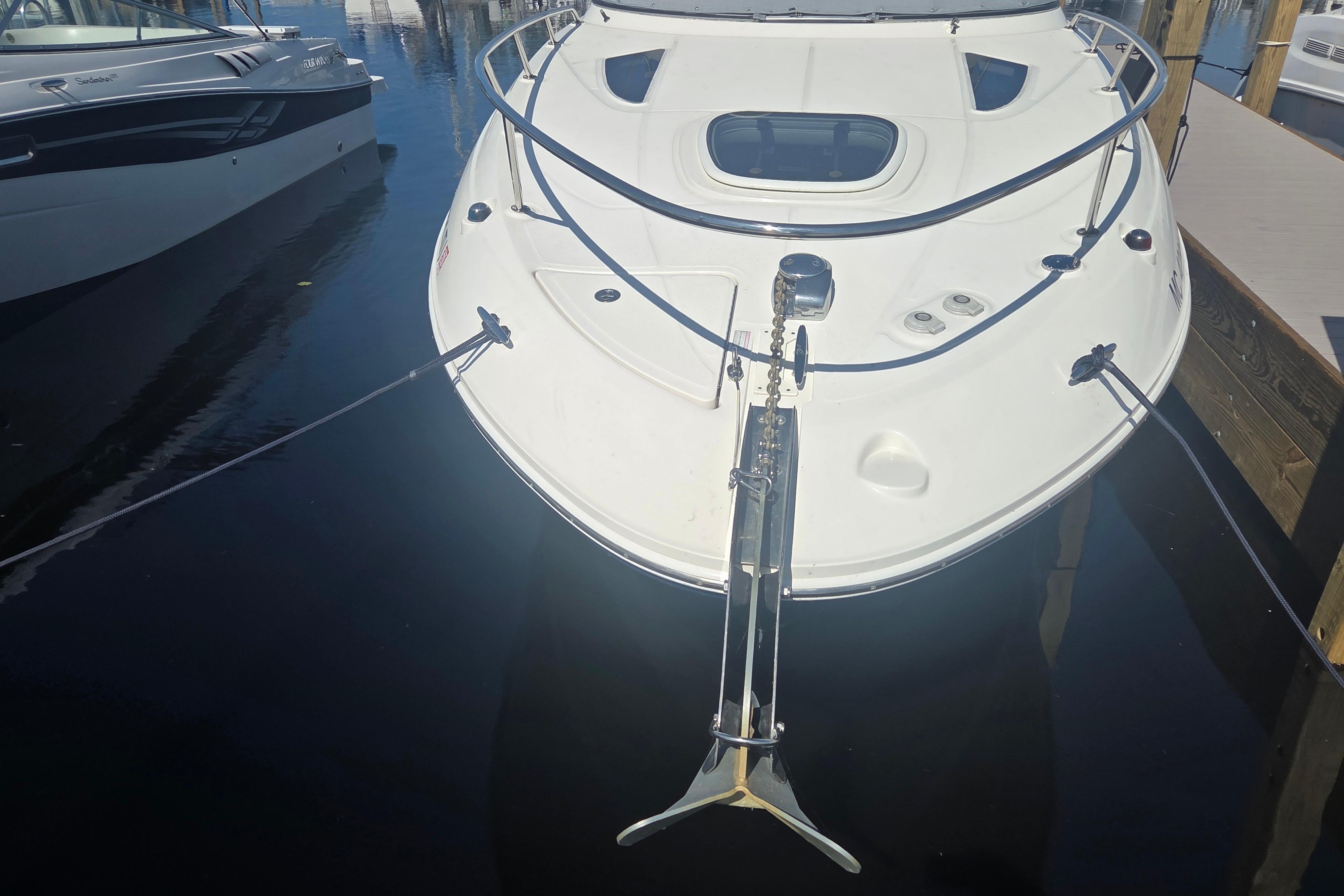 2012 Sea Ray Sundancer 260 docked, showcasing sleek design and anchor.