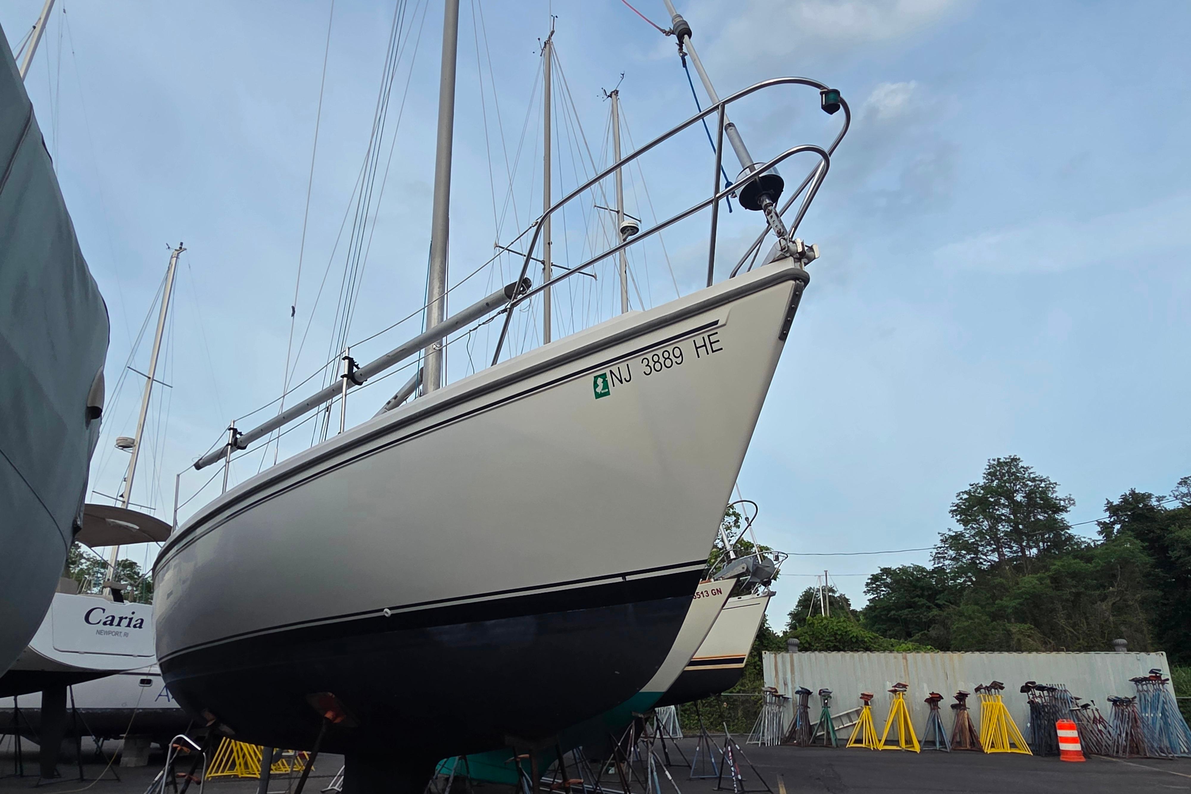 1986 Catalina 355 sailboat on dry dock, surrounded by other boats and equipment.
