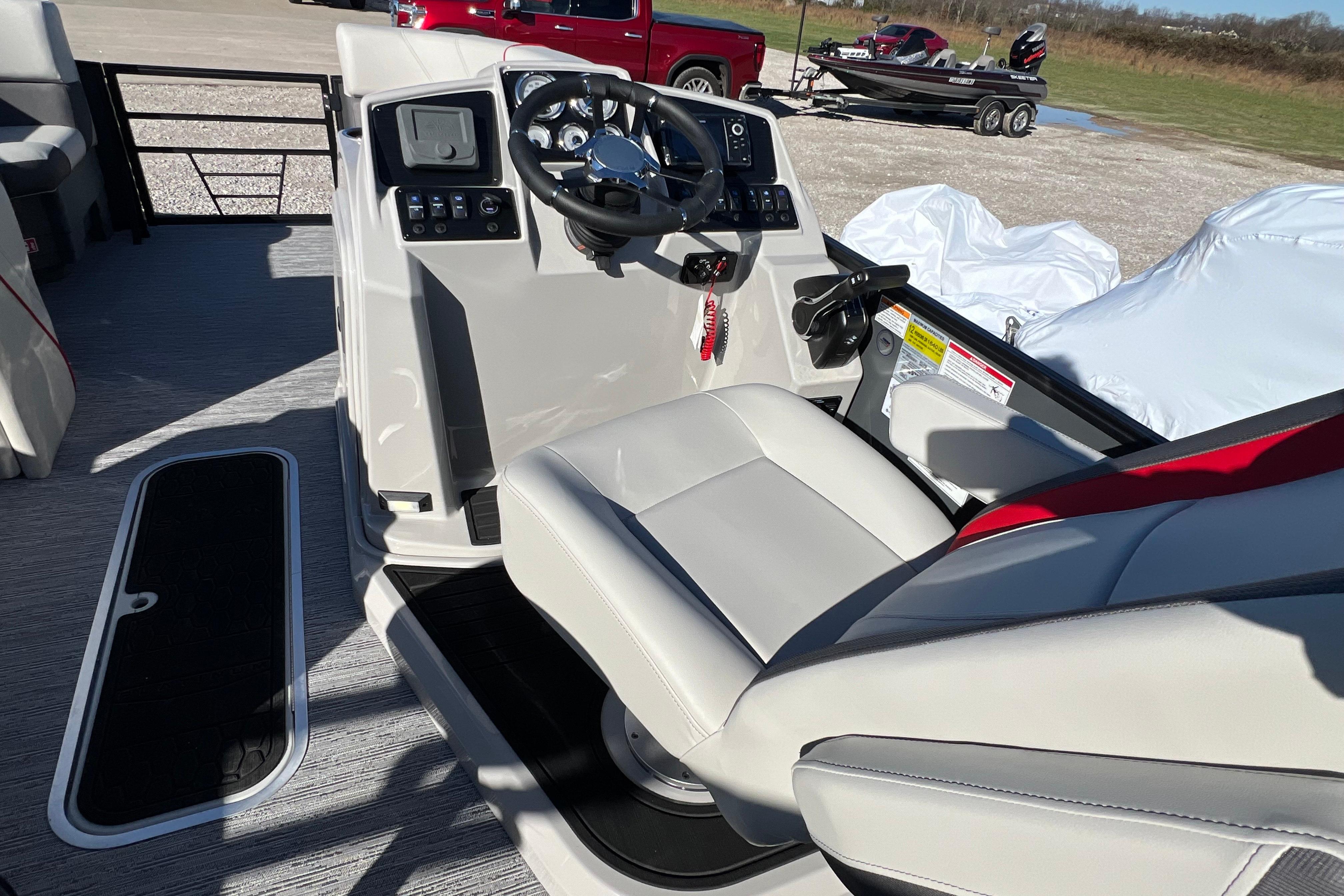 2026 Sylvan X3 DLZ Bar boat interior with steering console and seating.