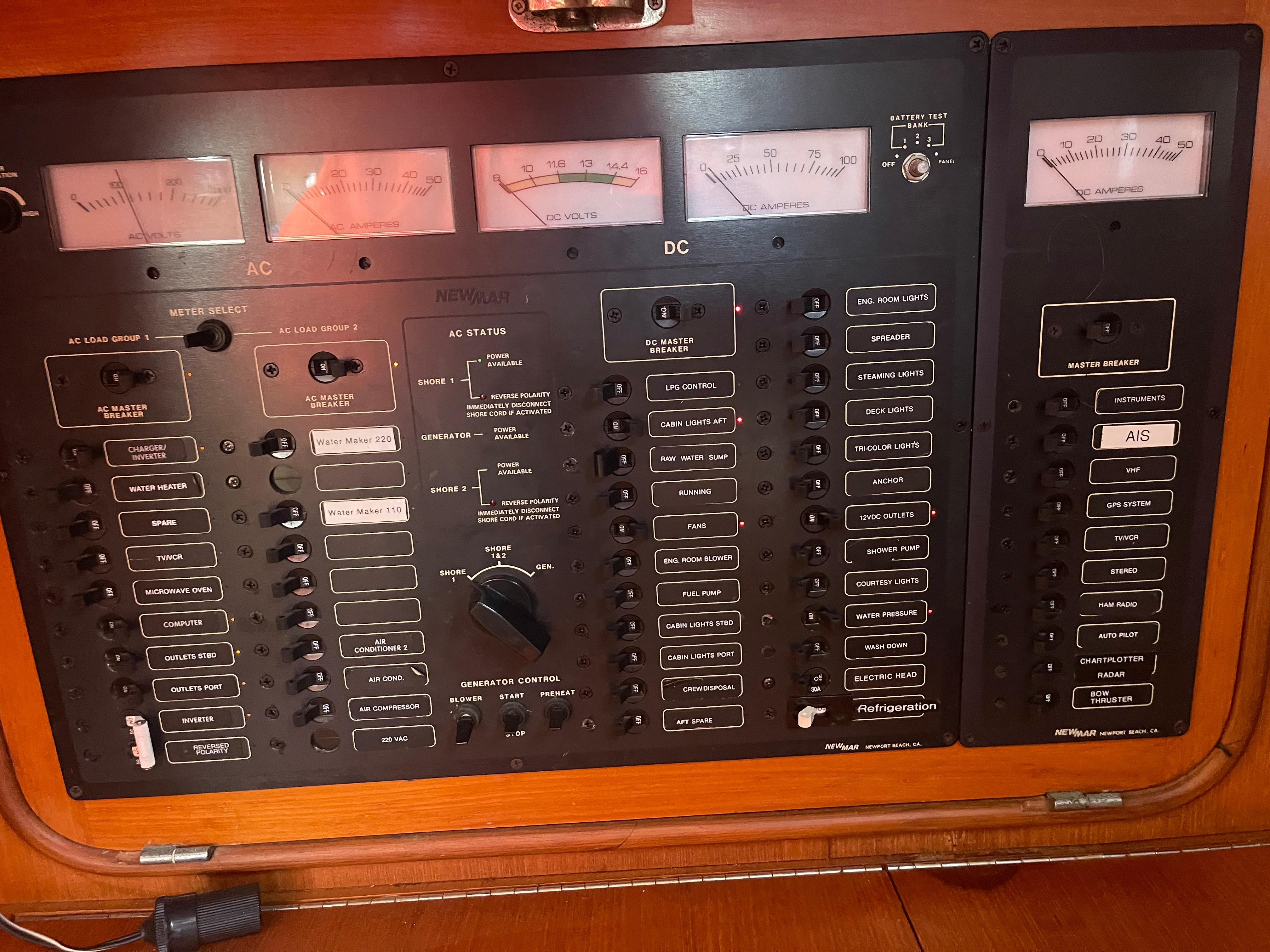 Control panel of a 1995 Passport 47 AC Plan B yacht with AC and DC switches.
