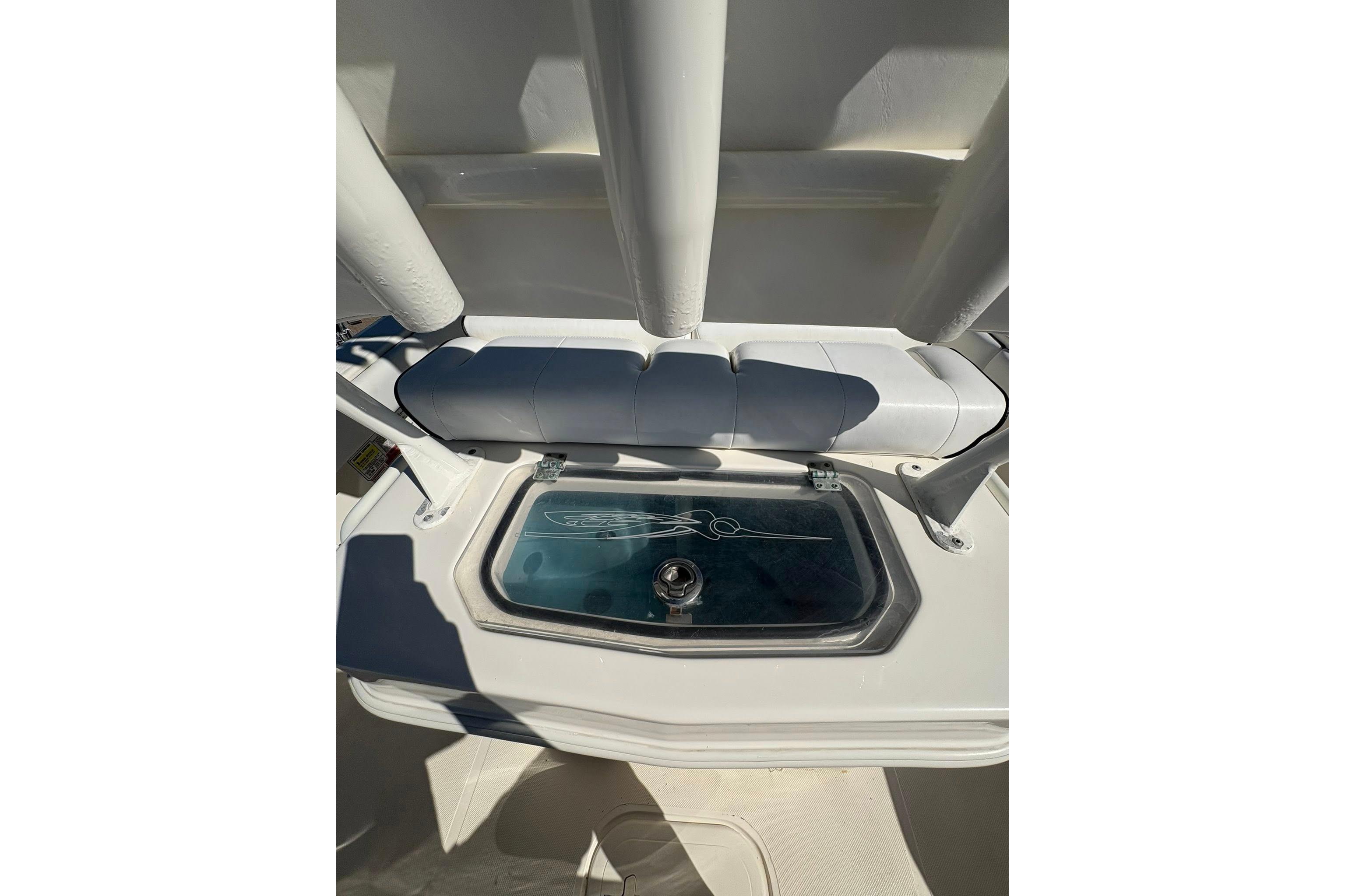 2023 Skeeter SX2550 Family boat interior with storage compartment and cushioned seating.