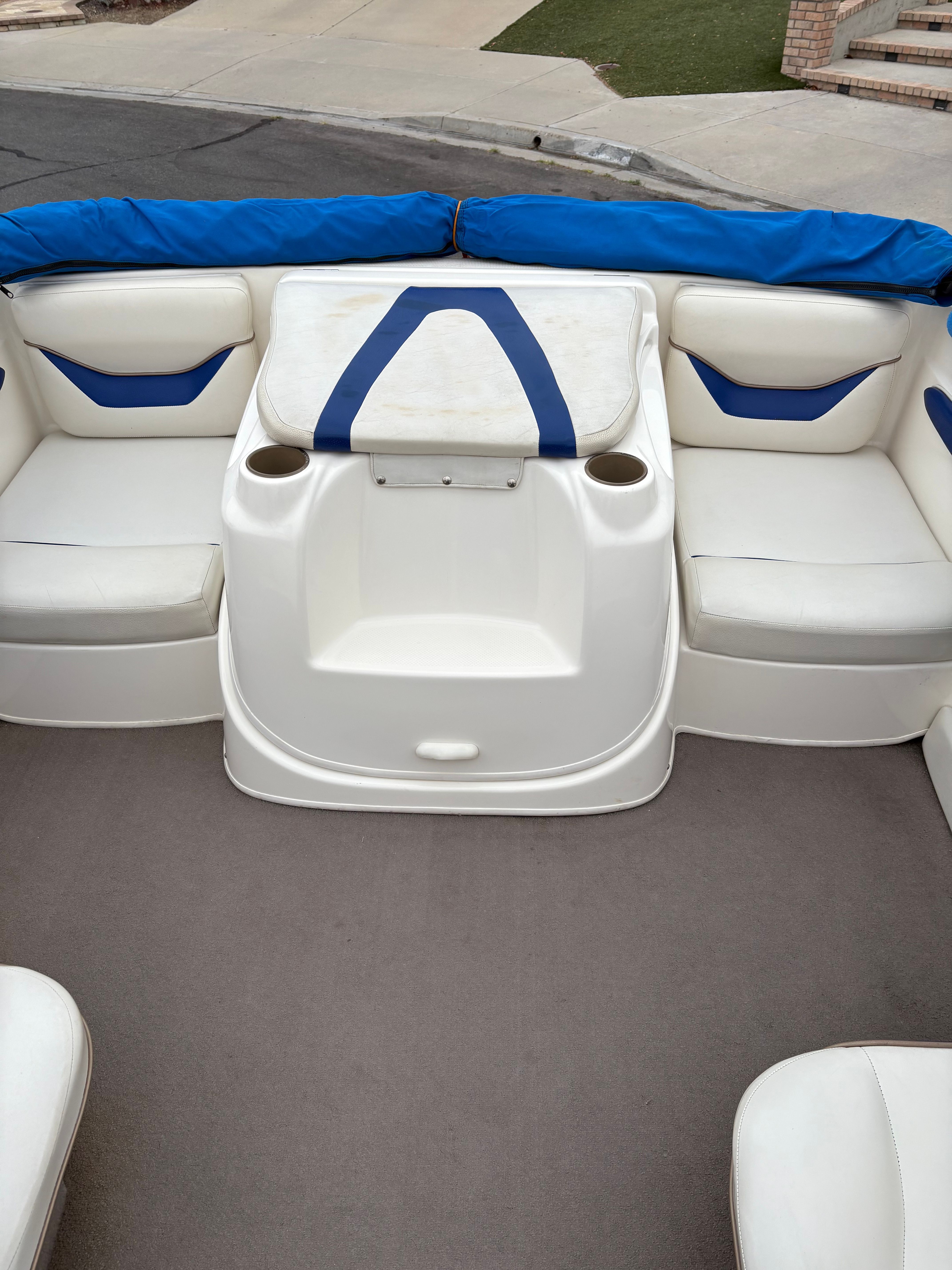 2003 Bayliner CAPRI 205 boat interior with white and blue seating.