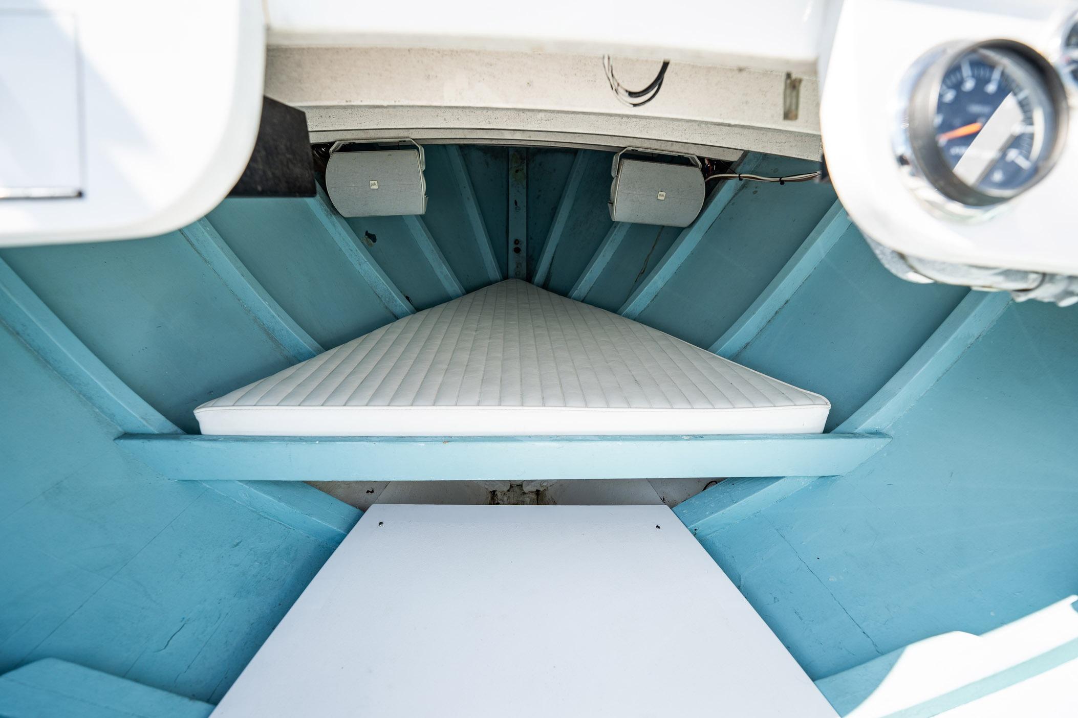 Interior cabin of 1982 Albury Brothers Runabout with blue walls and white mattress.