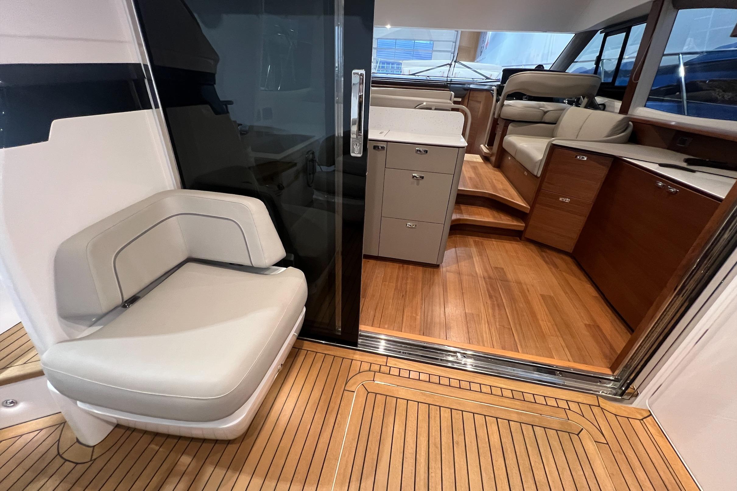 Interior view of 2019 Princess F45 yacht, featuring elegant seating and wooden flooring.