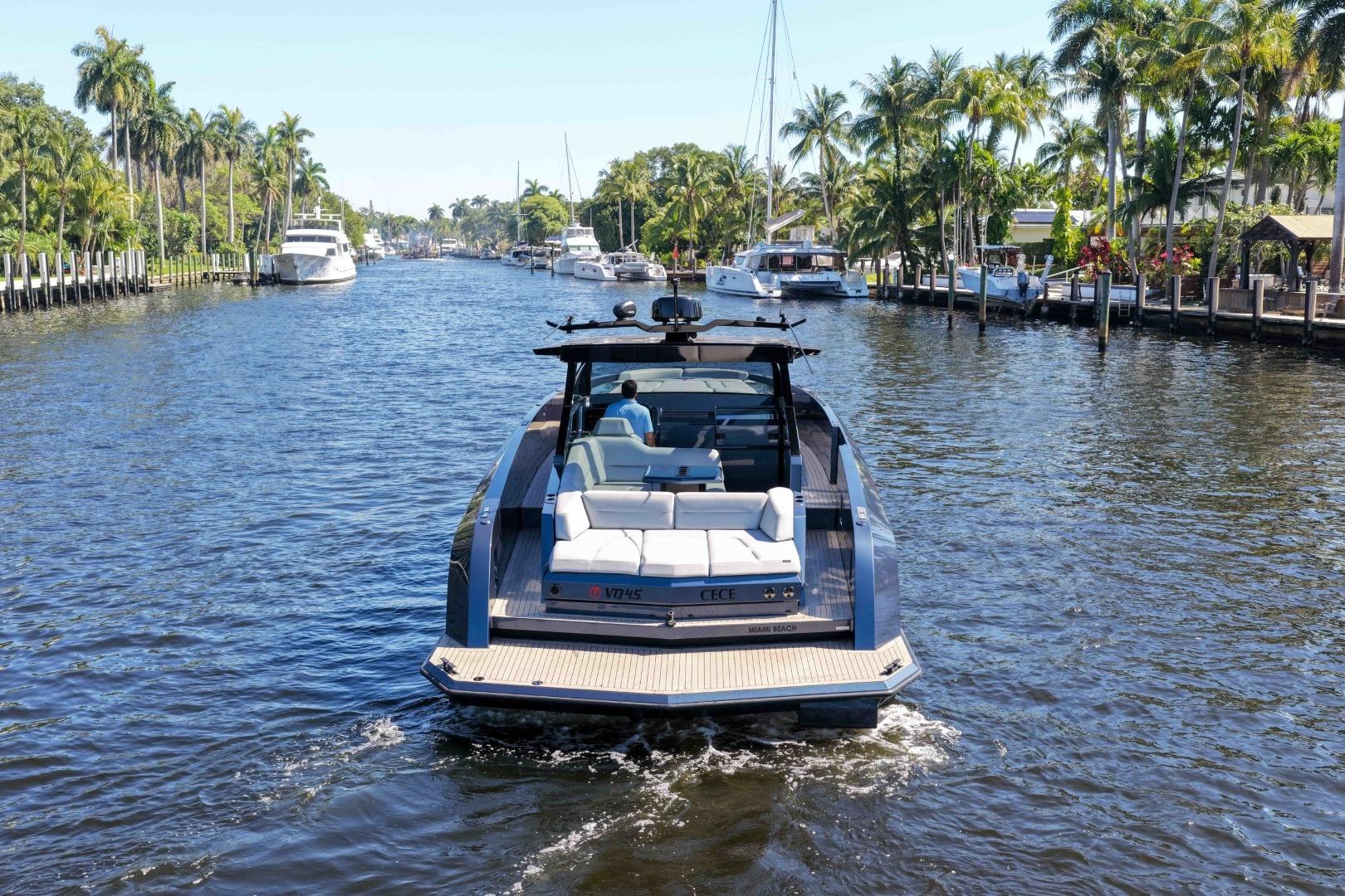 Vanquish Yachts VQ45 cruising a scenic waterway, surrounded by palm trees, 2022 model.