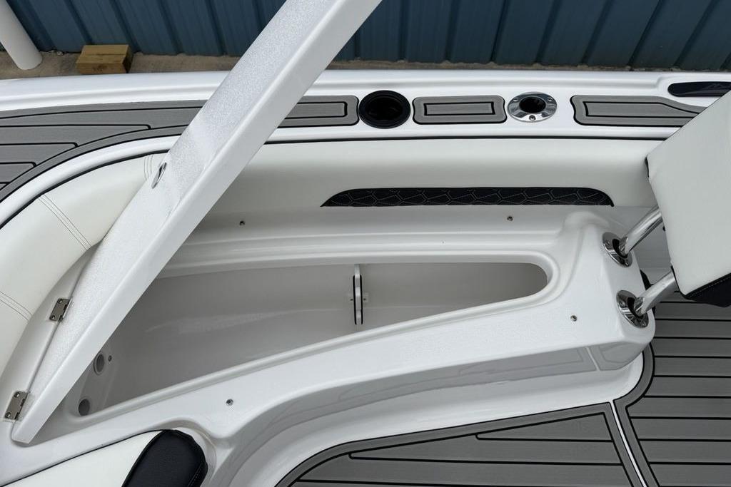 2026 Tidewater 2500 Carolina Bay boat interior storage compartment with sleek design and cup holders.