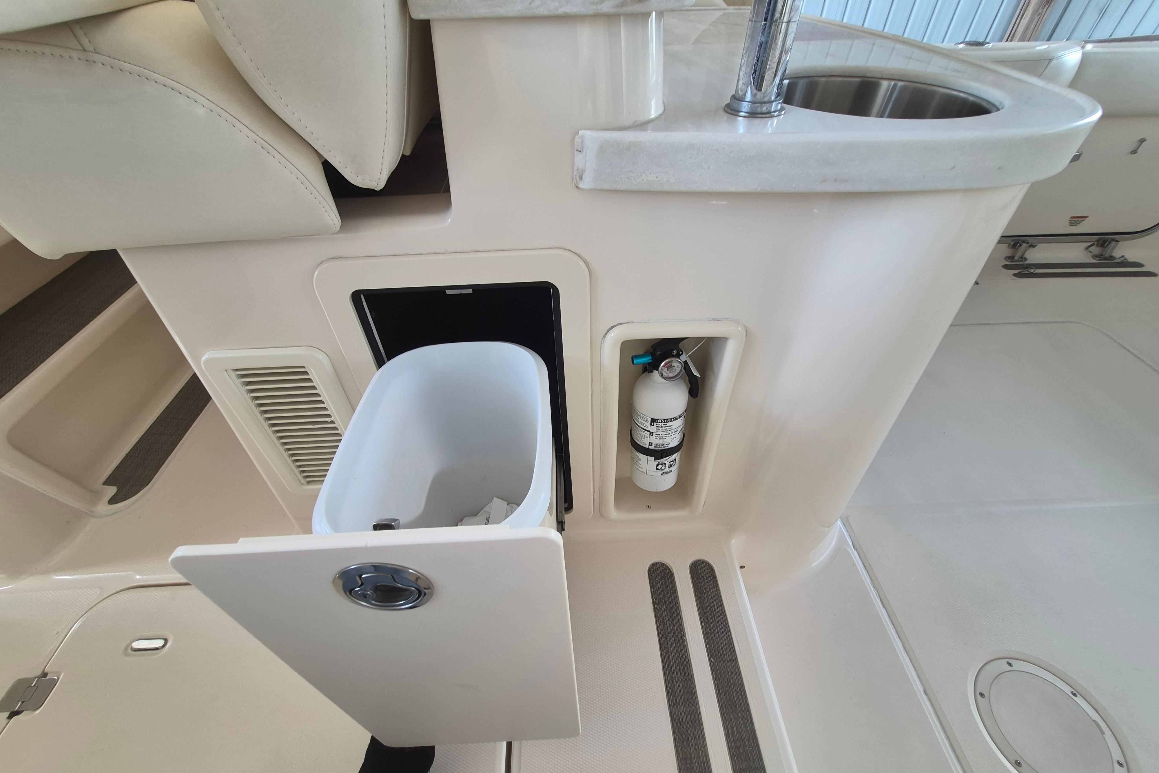 2019 Grady-White Freedom 335 boat interior with trash bin and fire extinguisher.