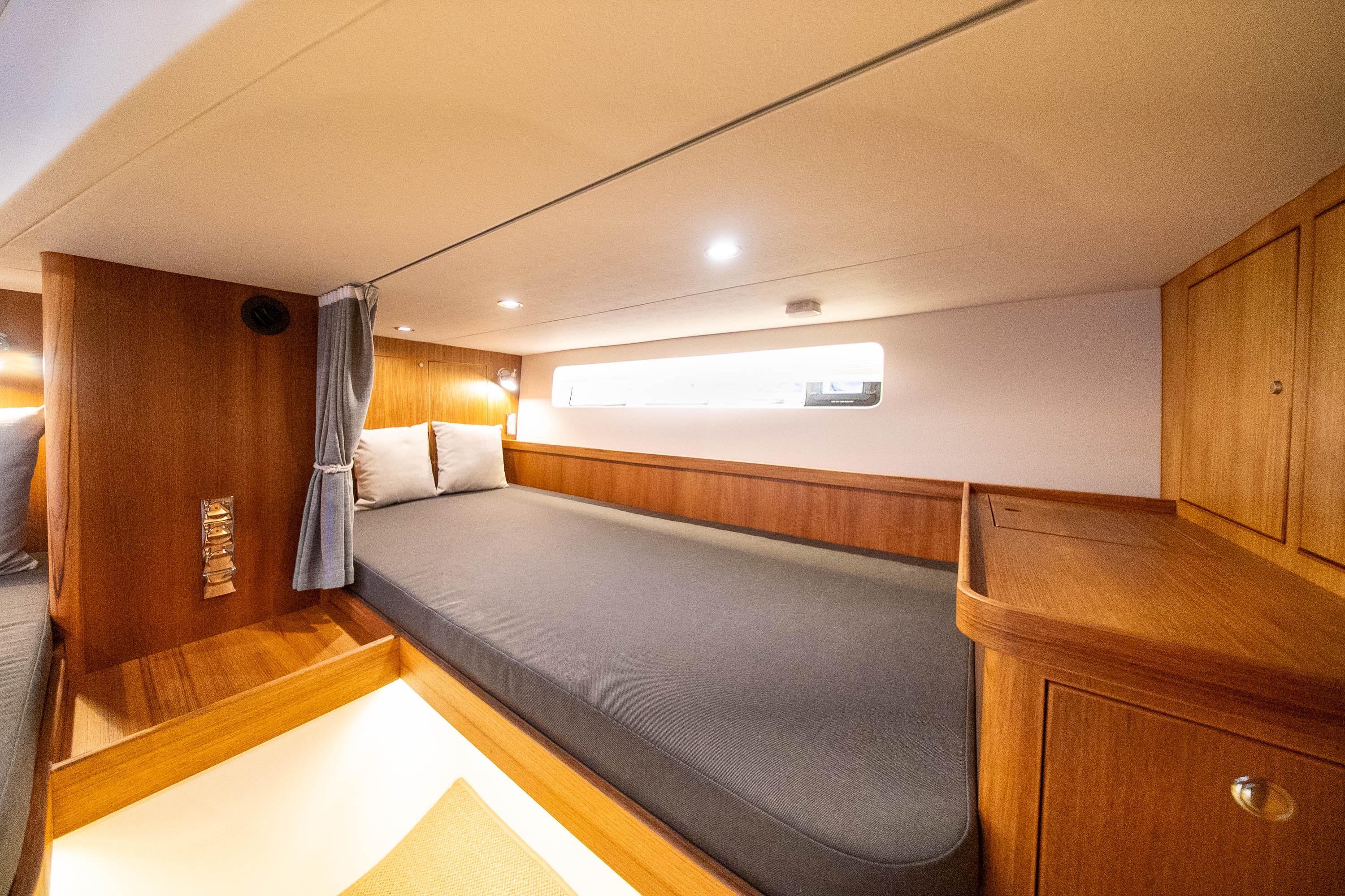 2026 Targa 41 yacht cabin with wooden interior and cozy bedding.