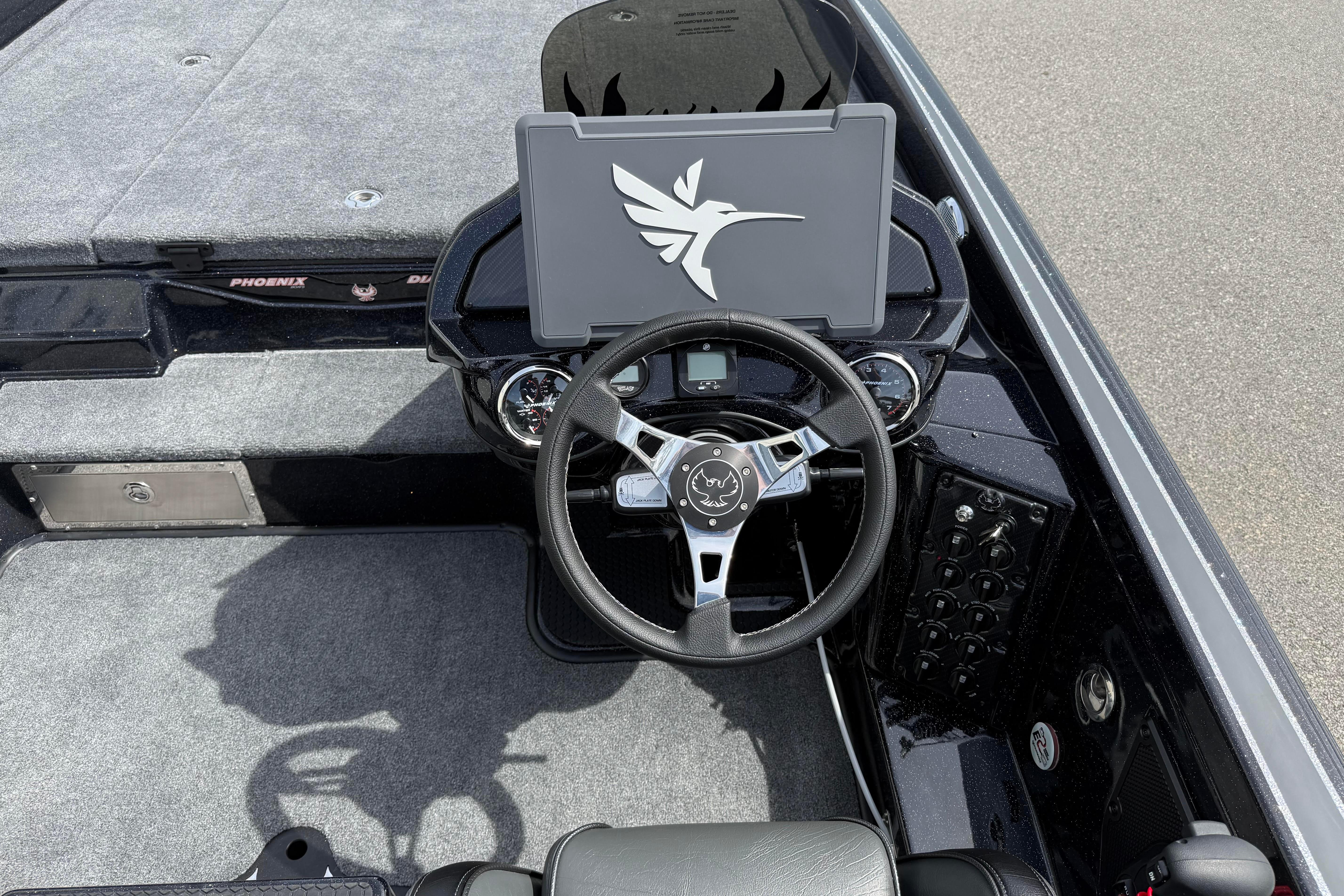 Cockpit of 2027 Phoenix 921 Elite X boat with steering wheel and control panel.