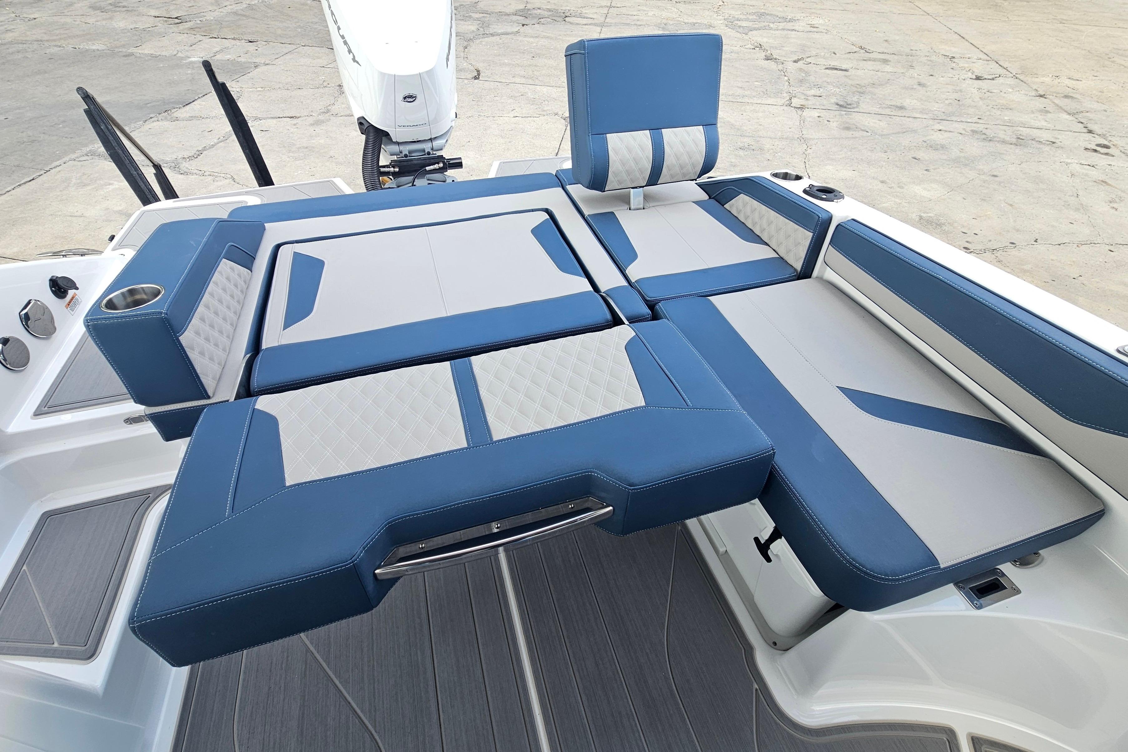 Luxury seating on 2026 Monterey Elite 27 OB boat, featuring blue and gray upholstery.
