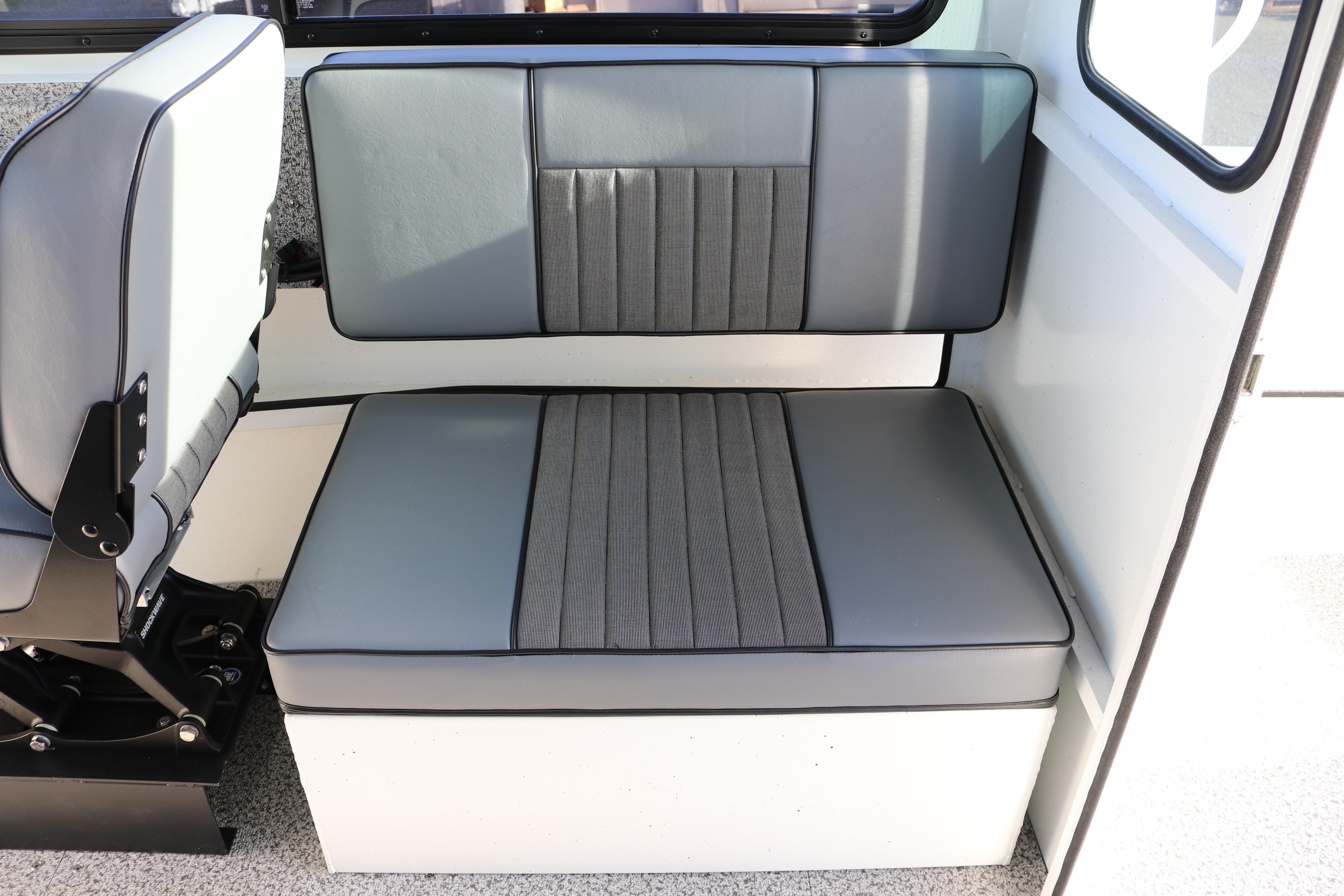 2026 Alumaweld Intruder Outboard 22 interior seating with gray upholstery and modern design.