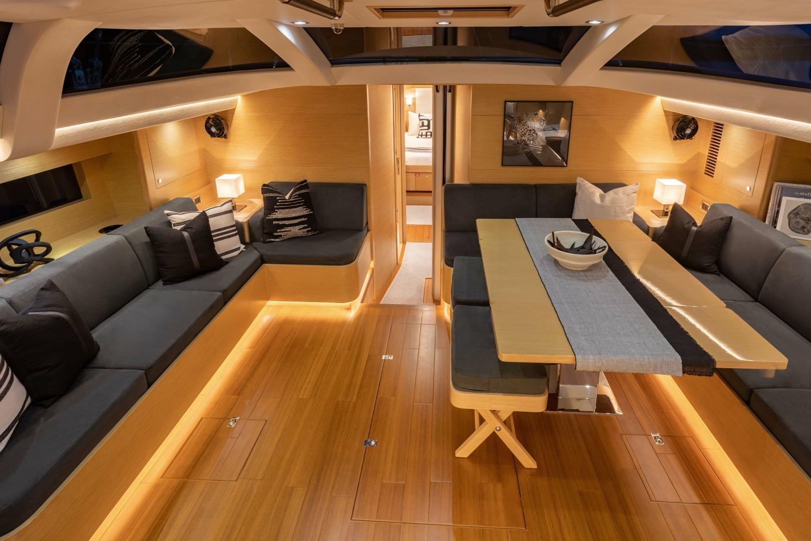 Luxurious interior of 2021 Hylas 57 yacht with elegant seating and dining area.