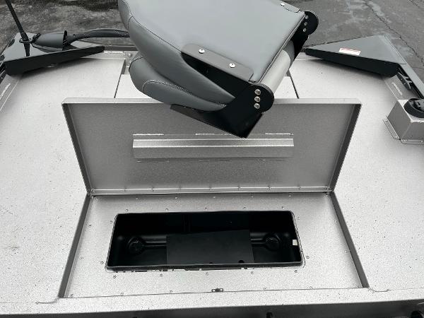 2024 Lowe Legacy boat with open storage compartment and gray seat.