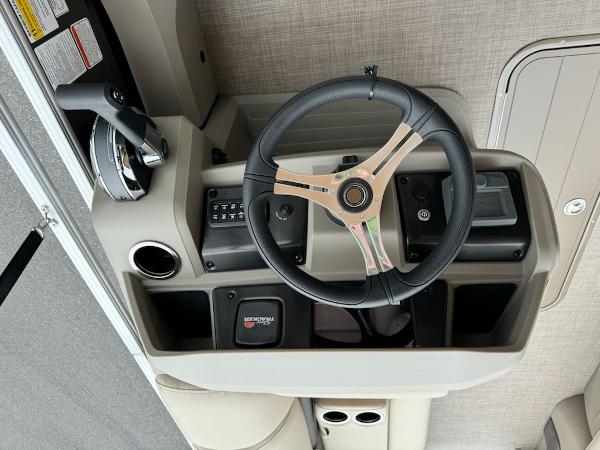 2025 Sun Tracker SportFish 22 XP3 steering console with modern controls and sleek design.