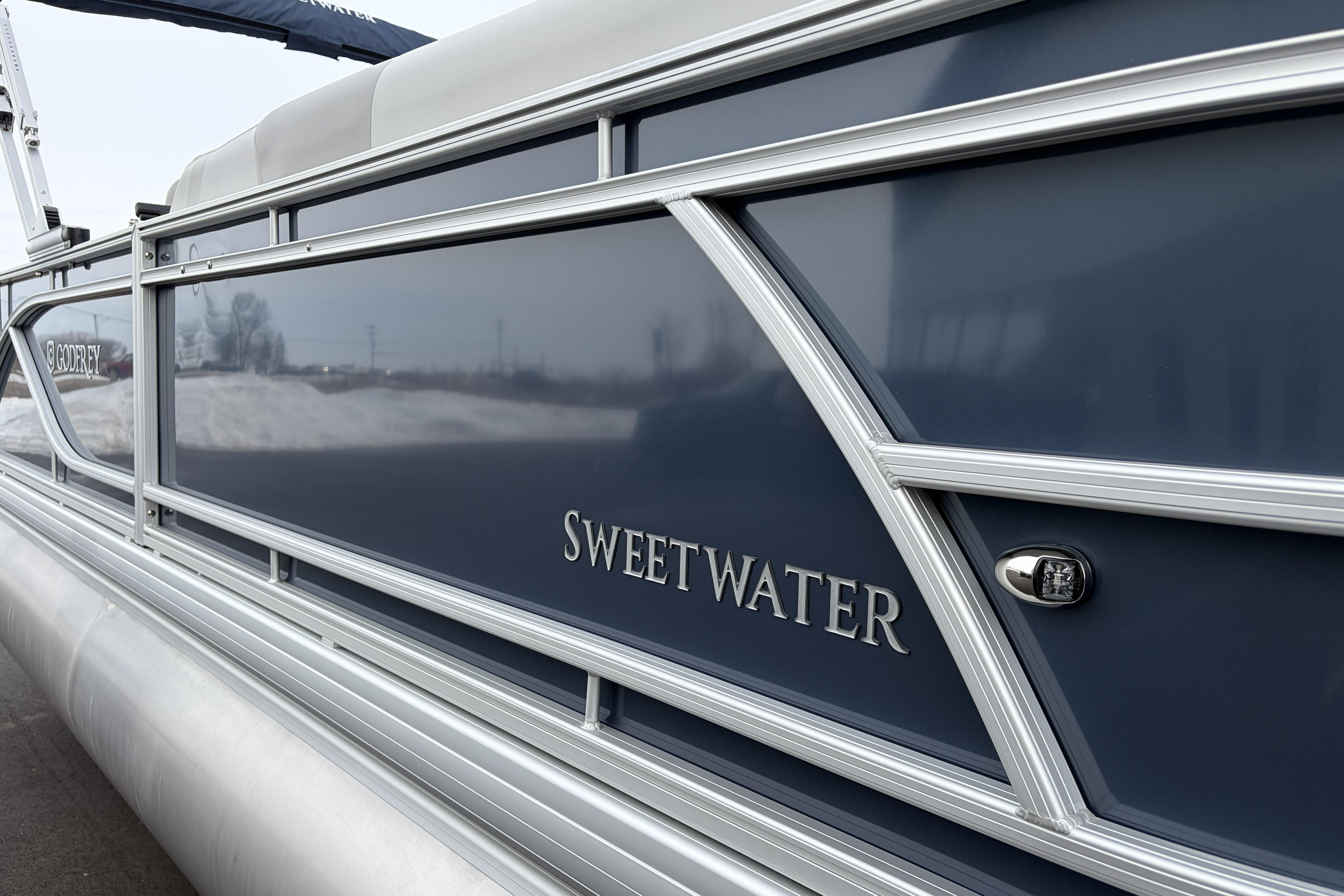 2026 Godfrey Sweetwater 2086 C pontoon boat with sleek blue exterior design.
