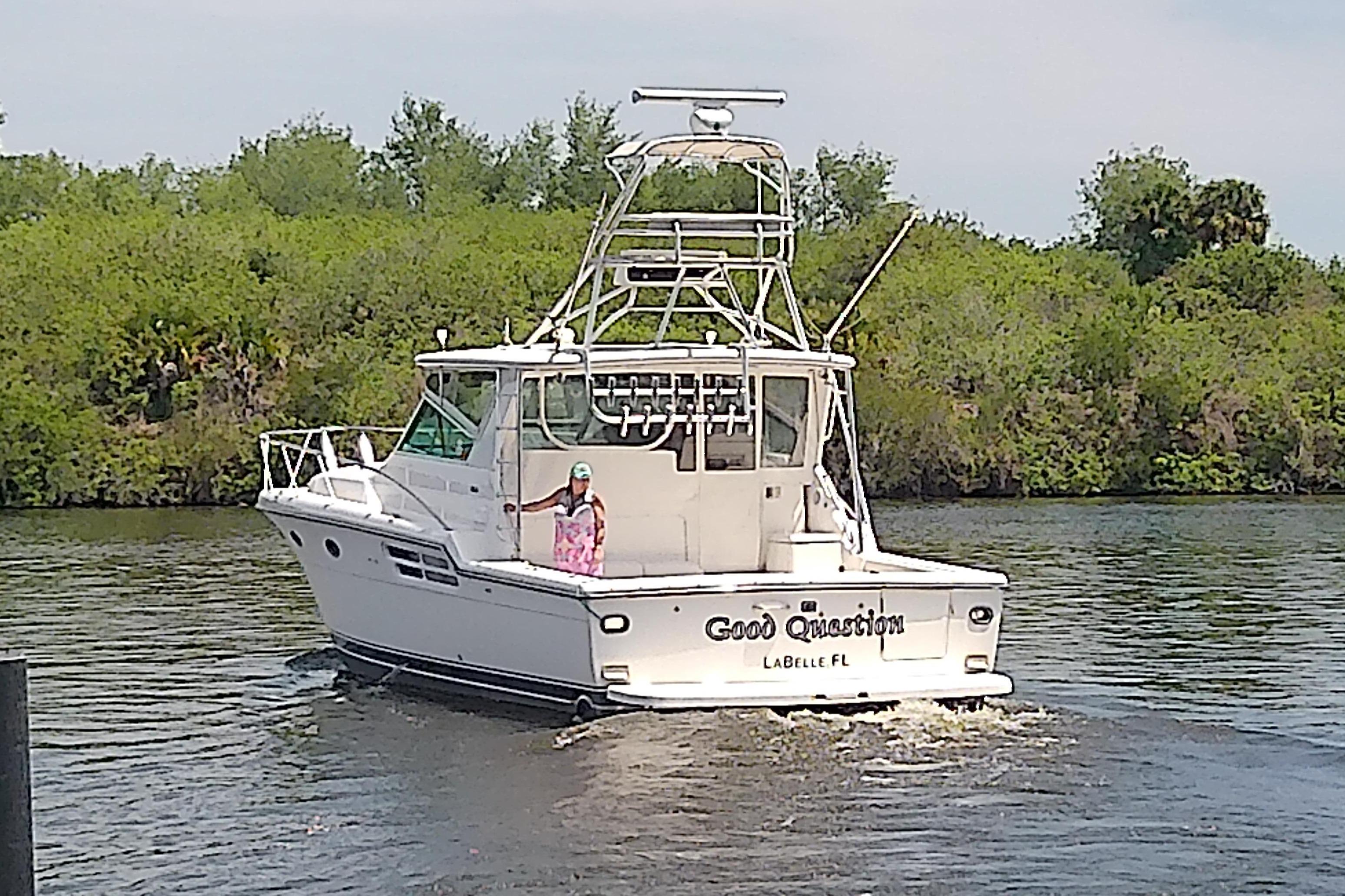 2000 Tiara Yachts 4100 Open cruising on a river, labeled "Good Question," LaBelle, FL.