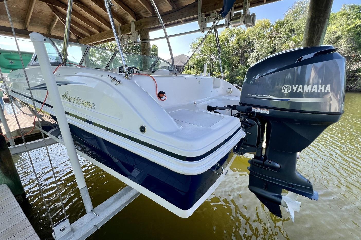 2013 Hurricane SunDeck 187 OB boat with Yamaha outboard motor on a lift.