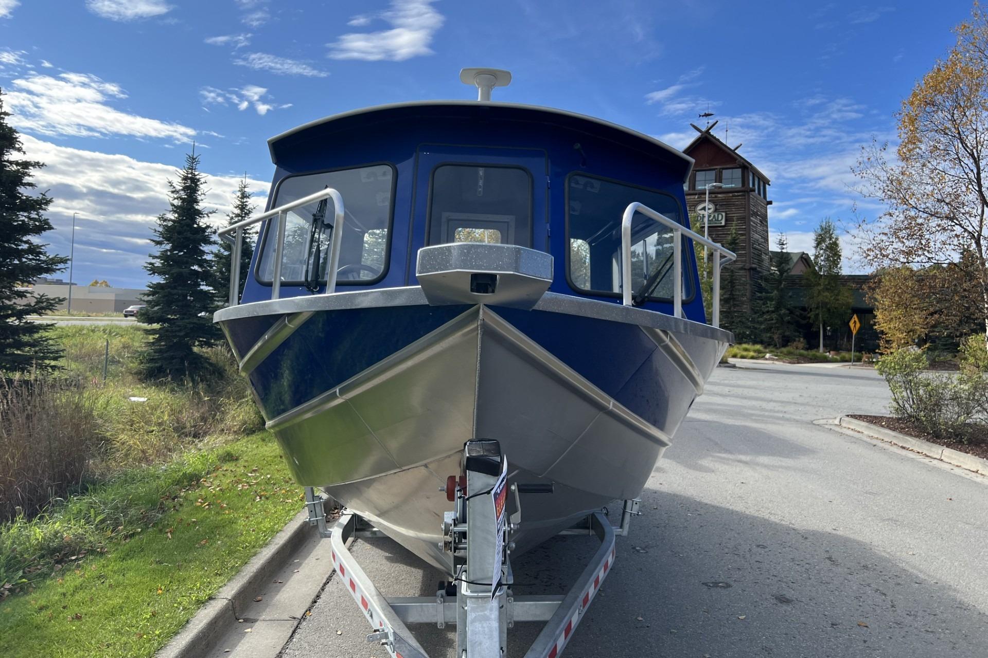 2024 Spartan 26 Maximus Pro XL boat on trailer, parked outdoors.