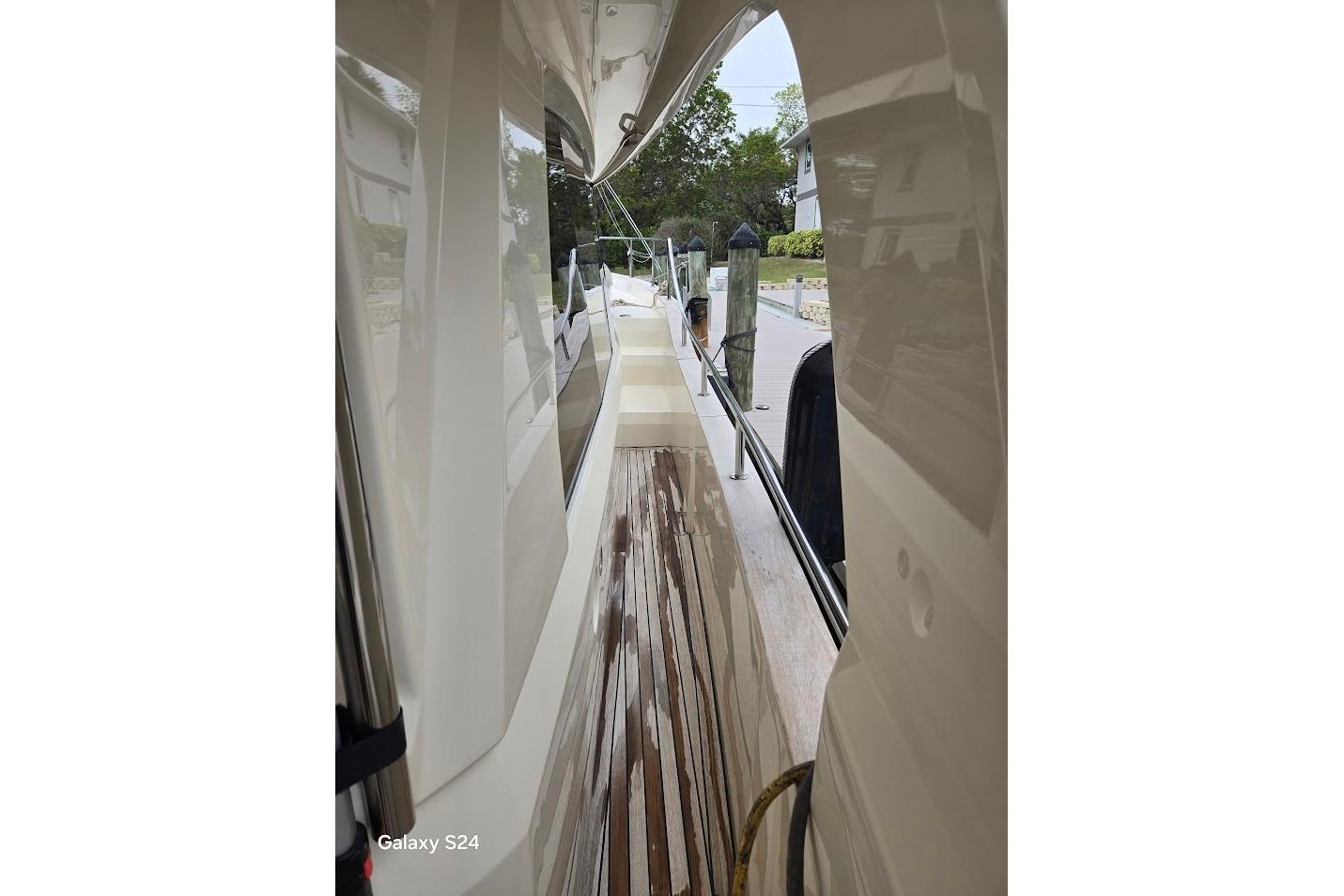 2019 Greenline 40 yacht side deck with polished wood finish and dock view.