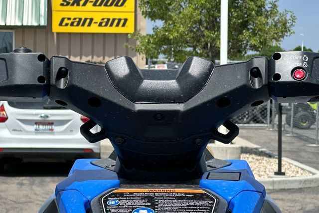 Close-up of a Yamaha WaveRunner Jetblaster handlebar, surrounded by buildings and cars.
