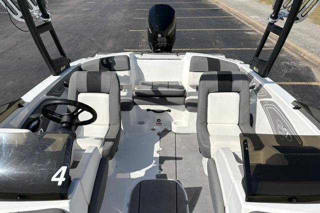 2024 Tahoe T21 boat interior with gray and white seating, steering wheel, and open deck layout.