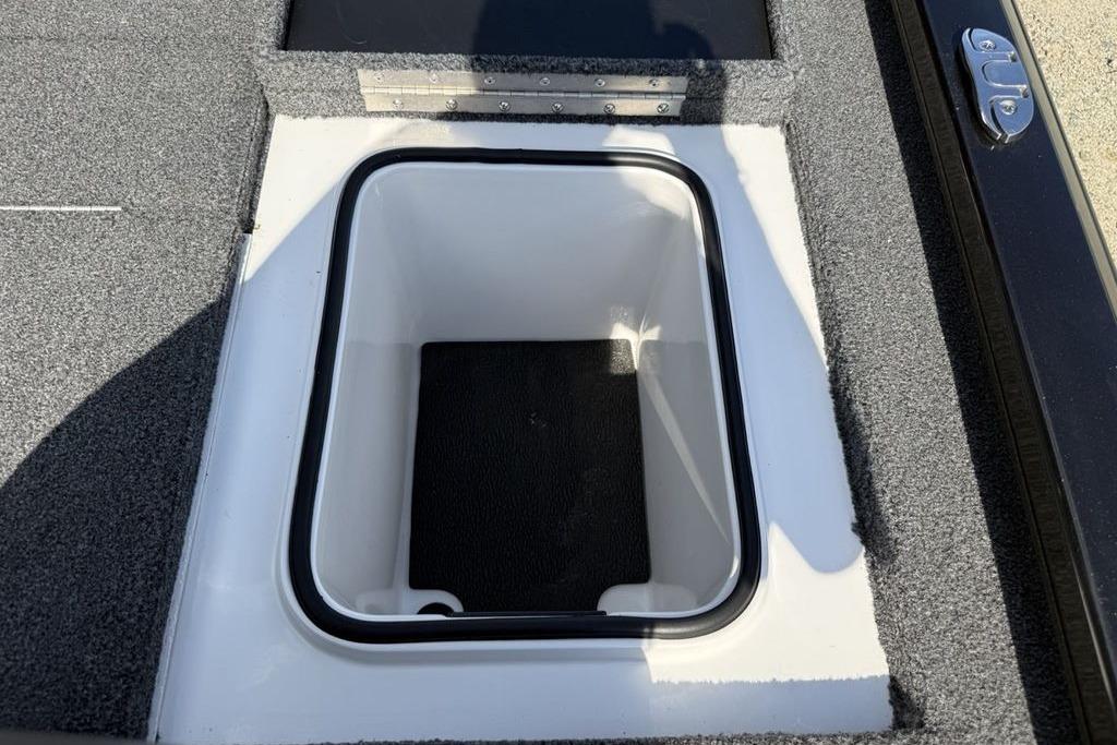 2023 Vexus AVX189 boat storage compartment with open lid, featuring carpeted interior.