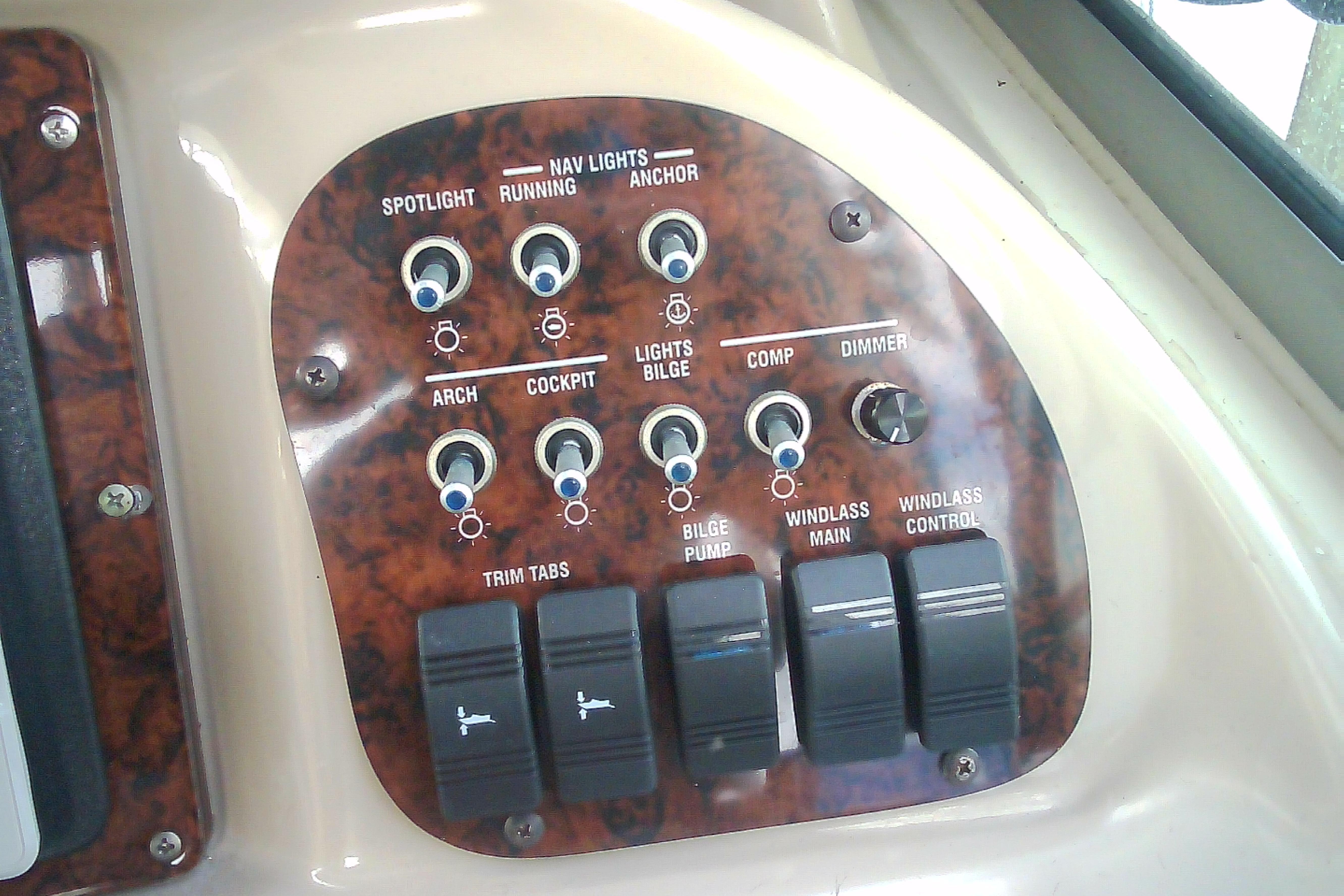 Control panel of a 2005 Sea Ray 300 Sundancer boat with various switches and dials.