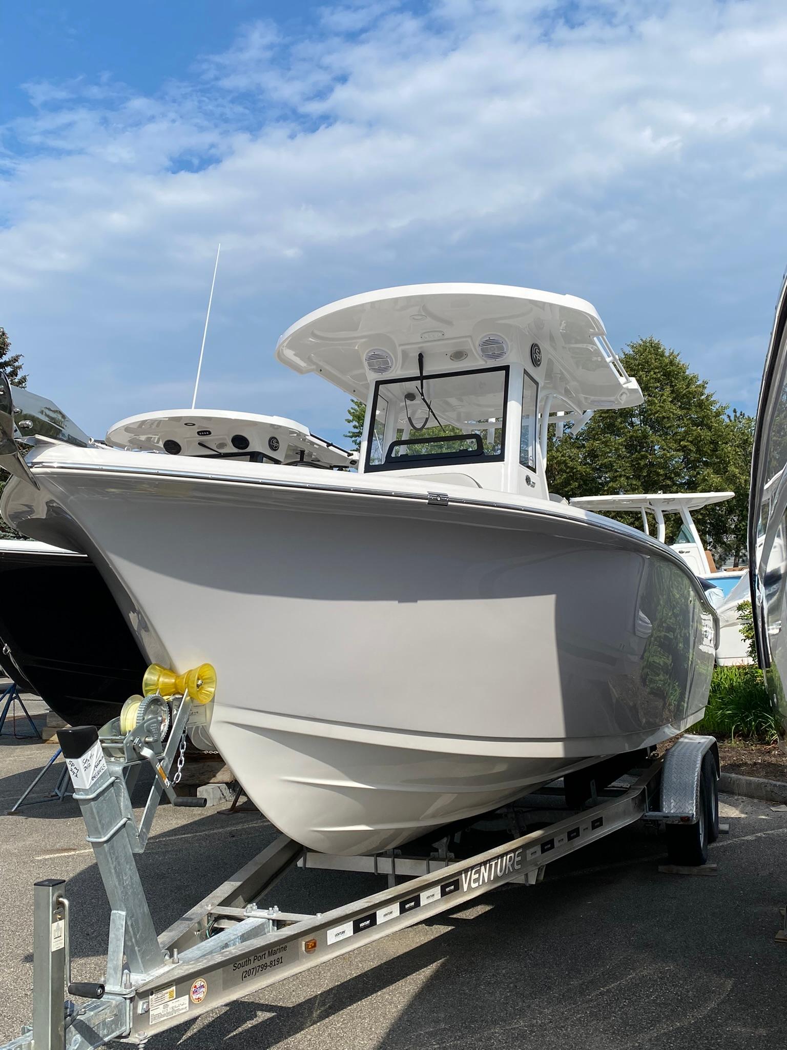 2025 Sea Pro 242 Center Console boat on trailer under blue sky.