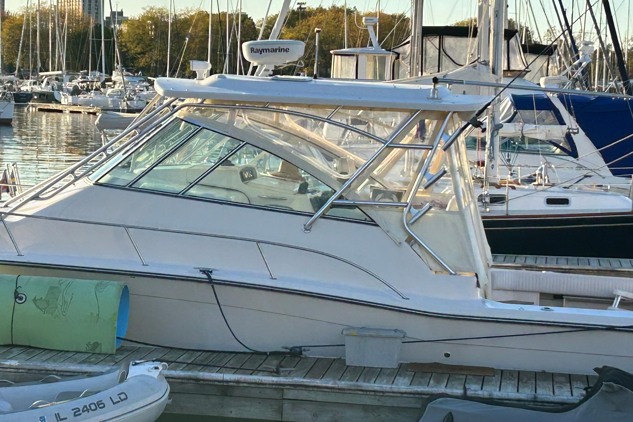2007 Grady-White Express 360 boat docked in a marina, surrounded by other vessels.