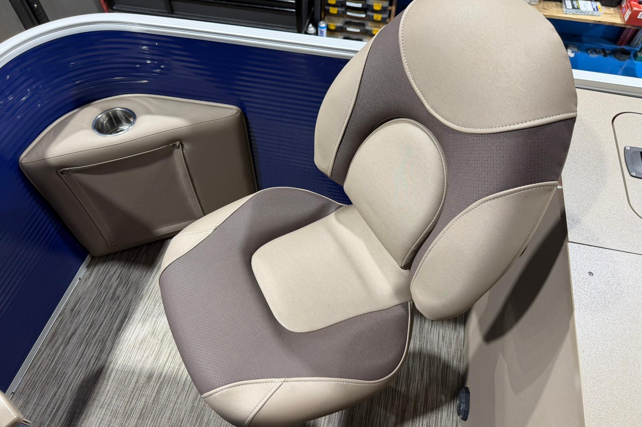 Comfortable seating on a 2020 Bennington SX 22 SFX boat with cup holder and storage pocket.