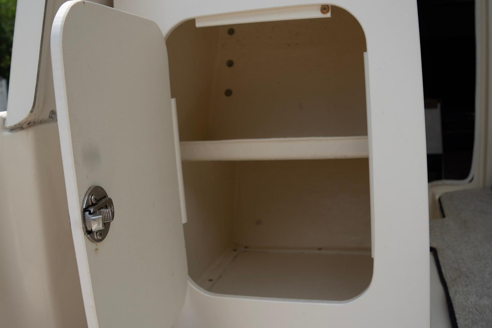 Open storage compartment on 2006 Atlas Boat Works Acadia 25, featuring a secure latch.