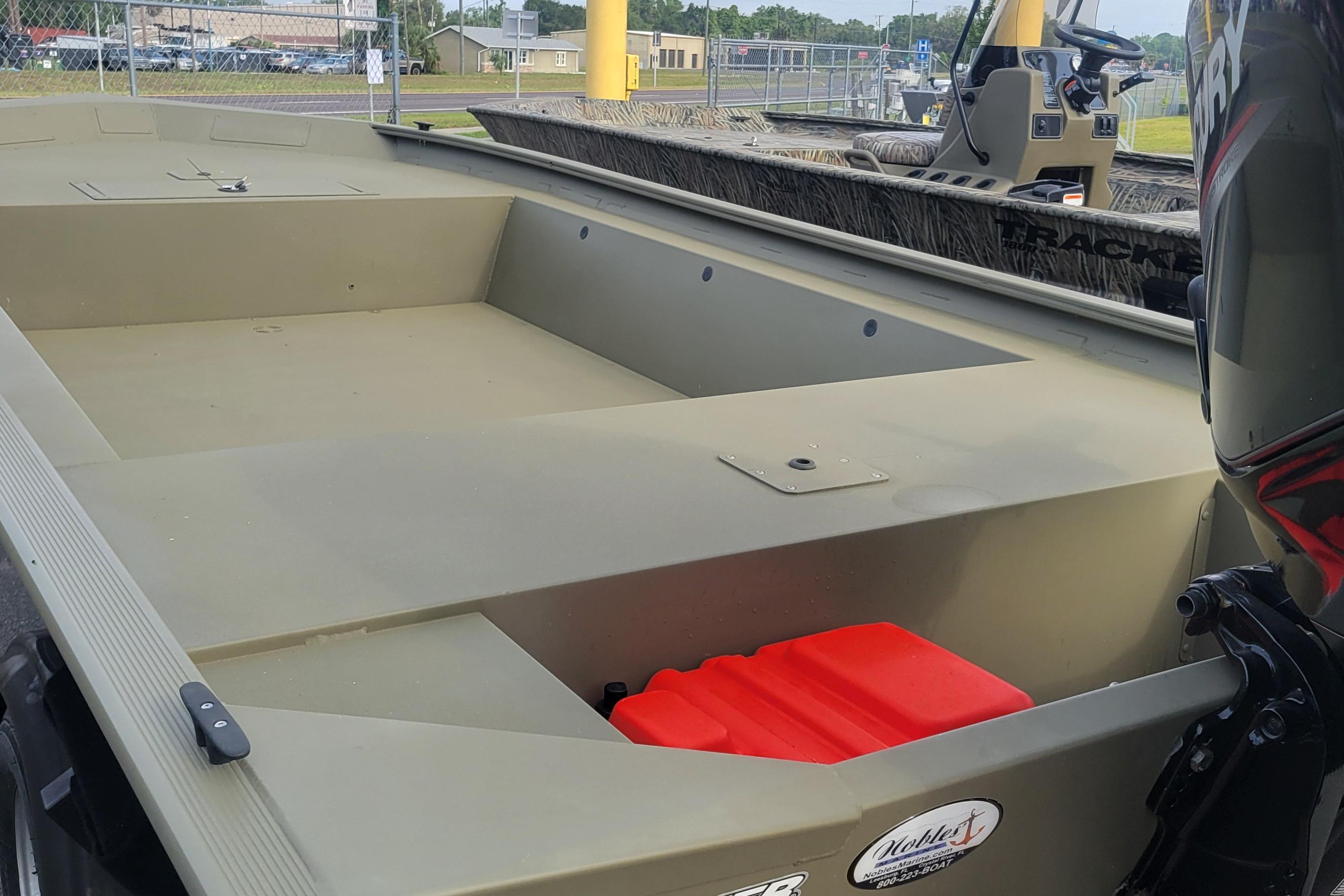 2026 Tracker Grizzly 1754 Utility boat interior with motor and storage compartment.