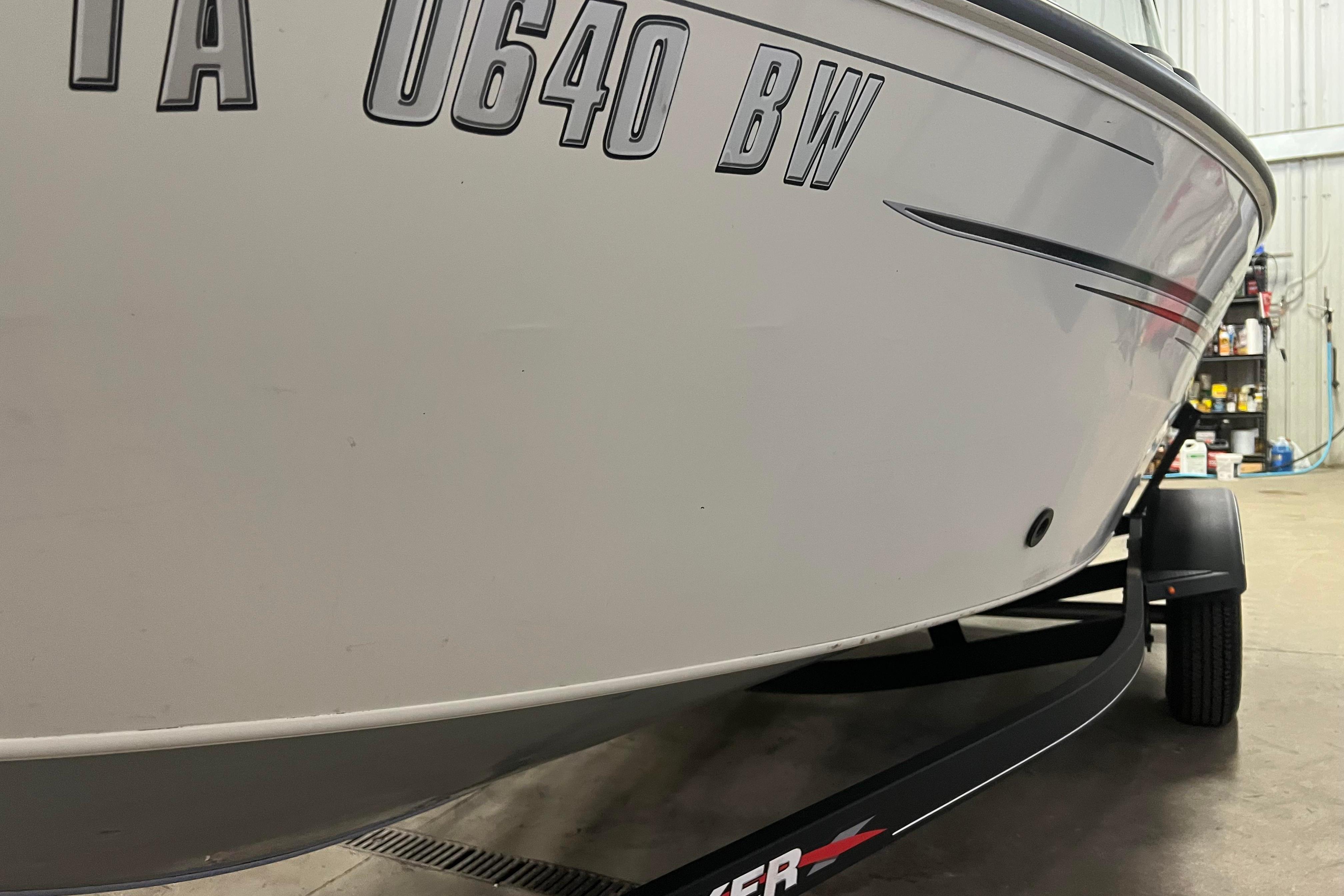 2022 Tracker Pro Guide V-16 WT boat on trailer in garage setting.