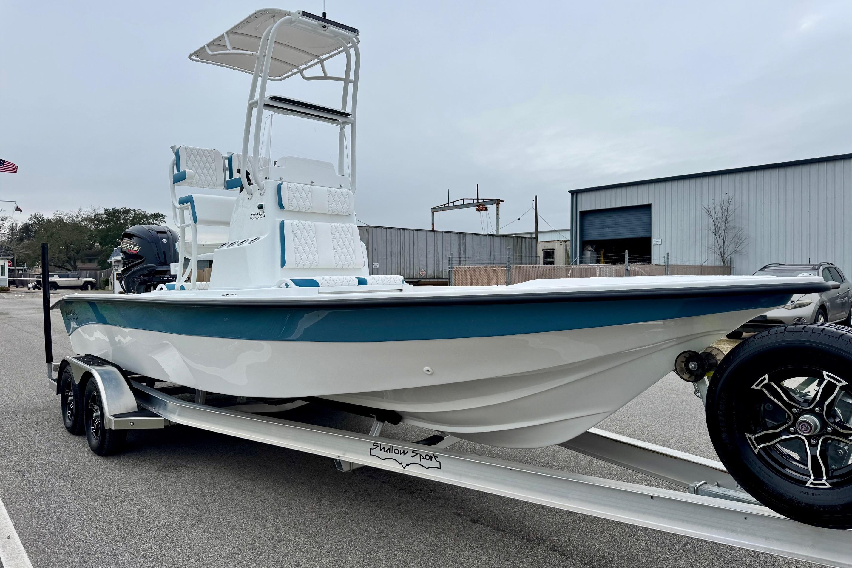 2026 Shallow Sport 24 Modified V boat on trailer, parked outdoors.