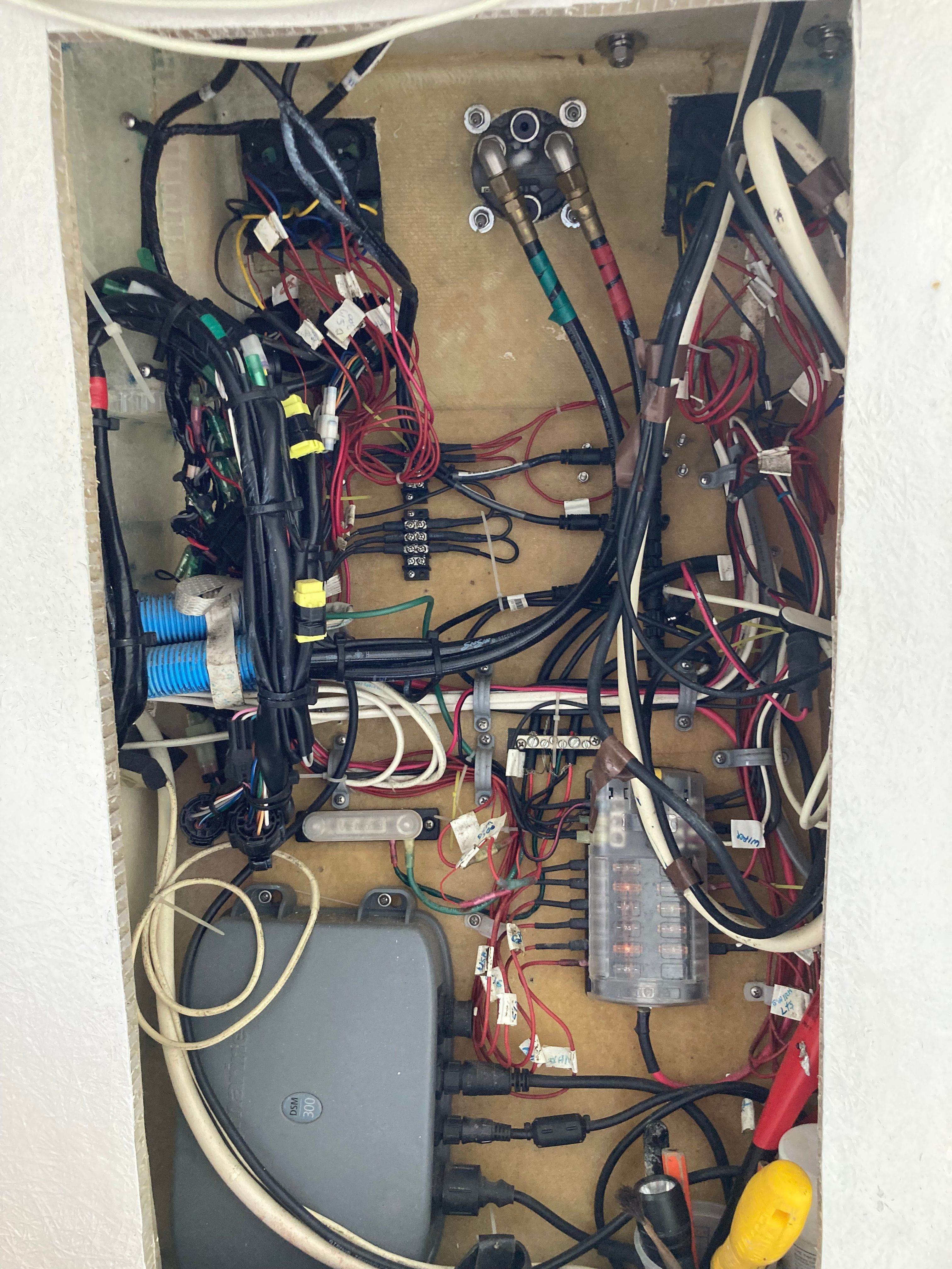 Electrical panel with wires and connections inside a boat.