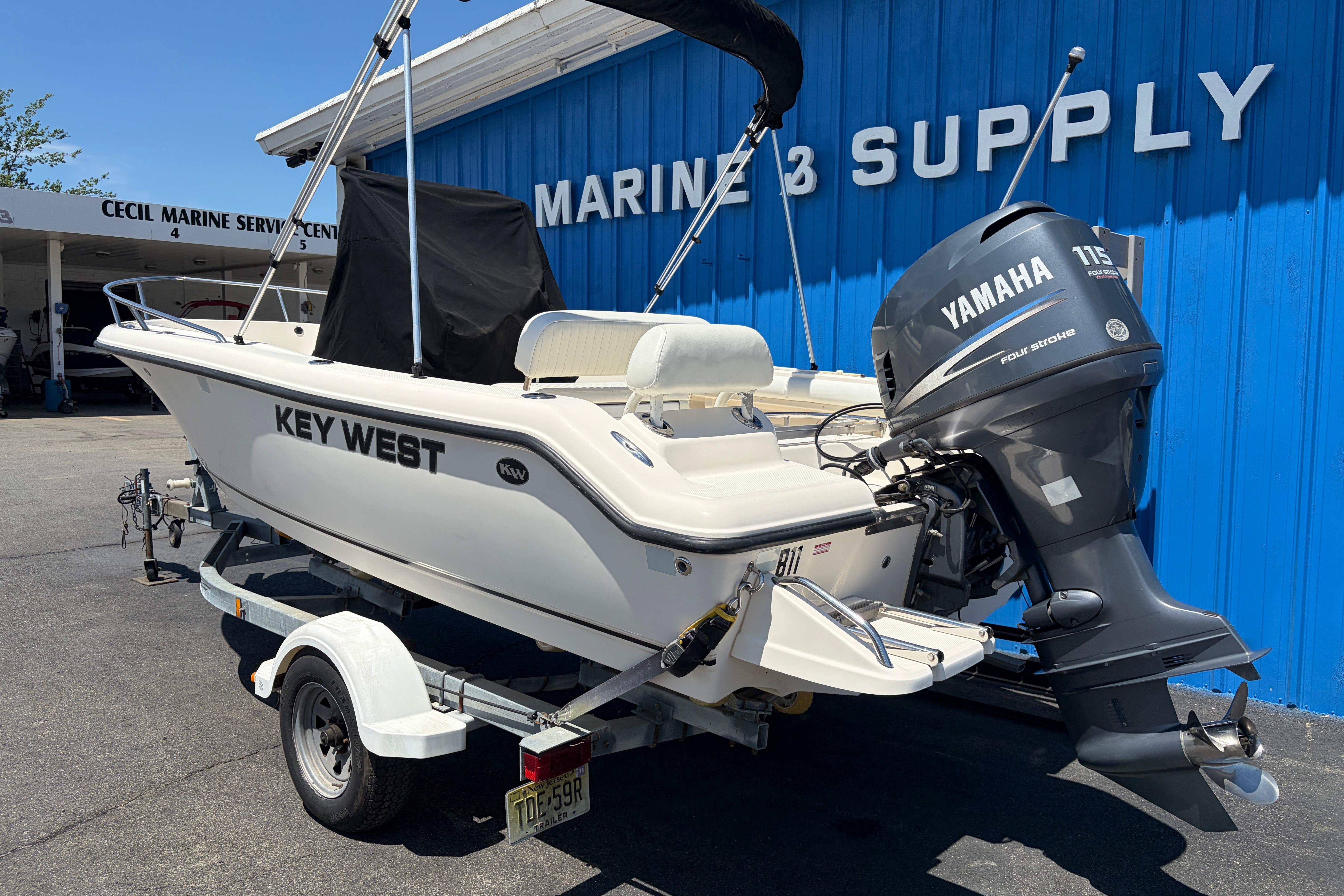 2006 Key West 186 Center Console boat with Yamaha engine at marine supply store.