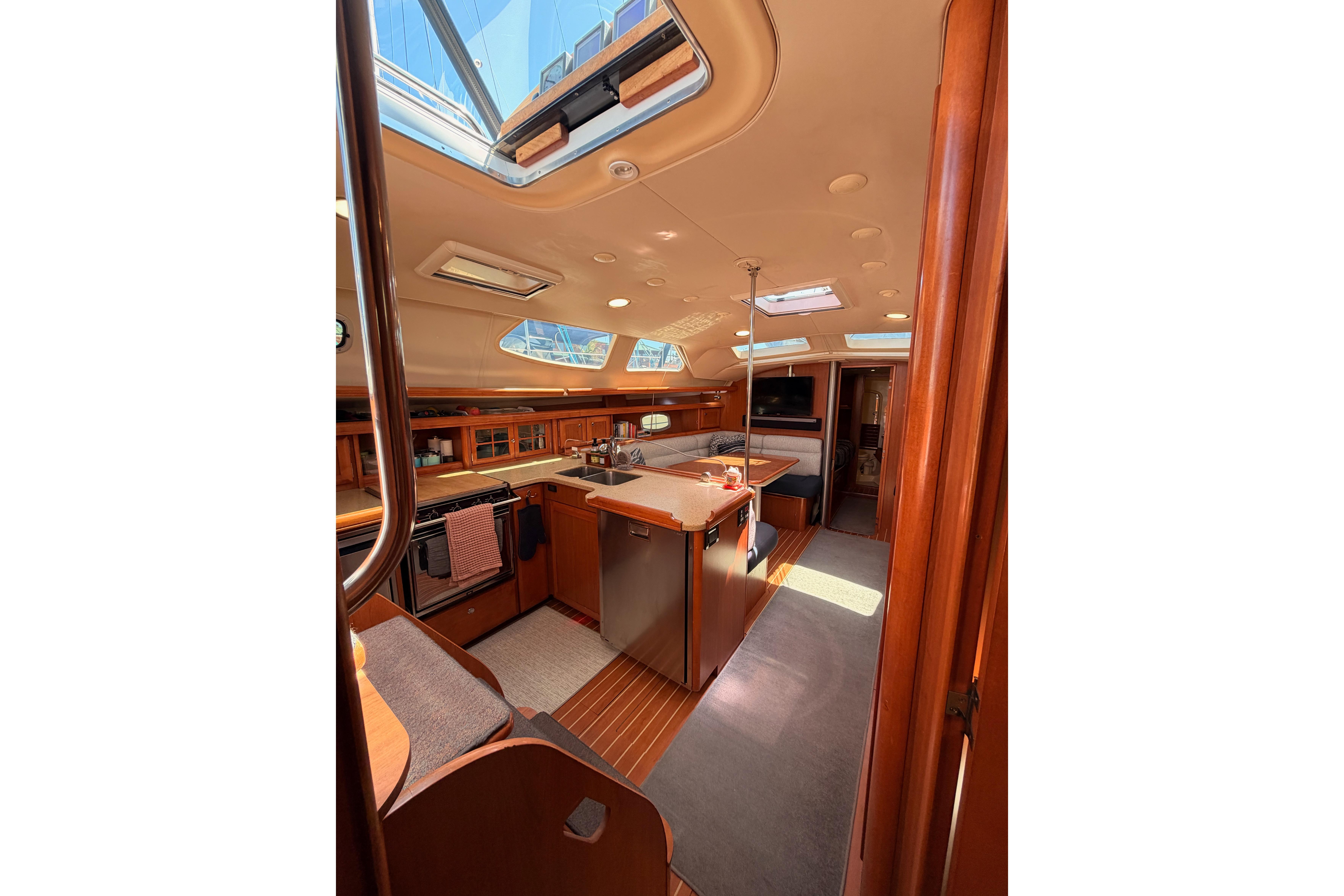 Interior of 2008 Hunter 45 Deck Salon yacht with spacious kitchen and seating area.