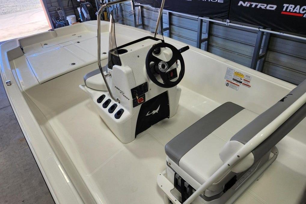 2026 Mako Pro Skiff 17 CC boat interior with steering console and seating.