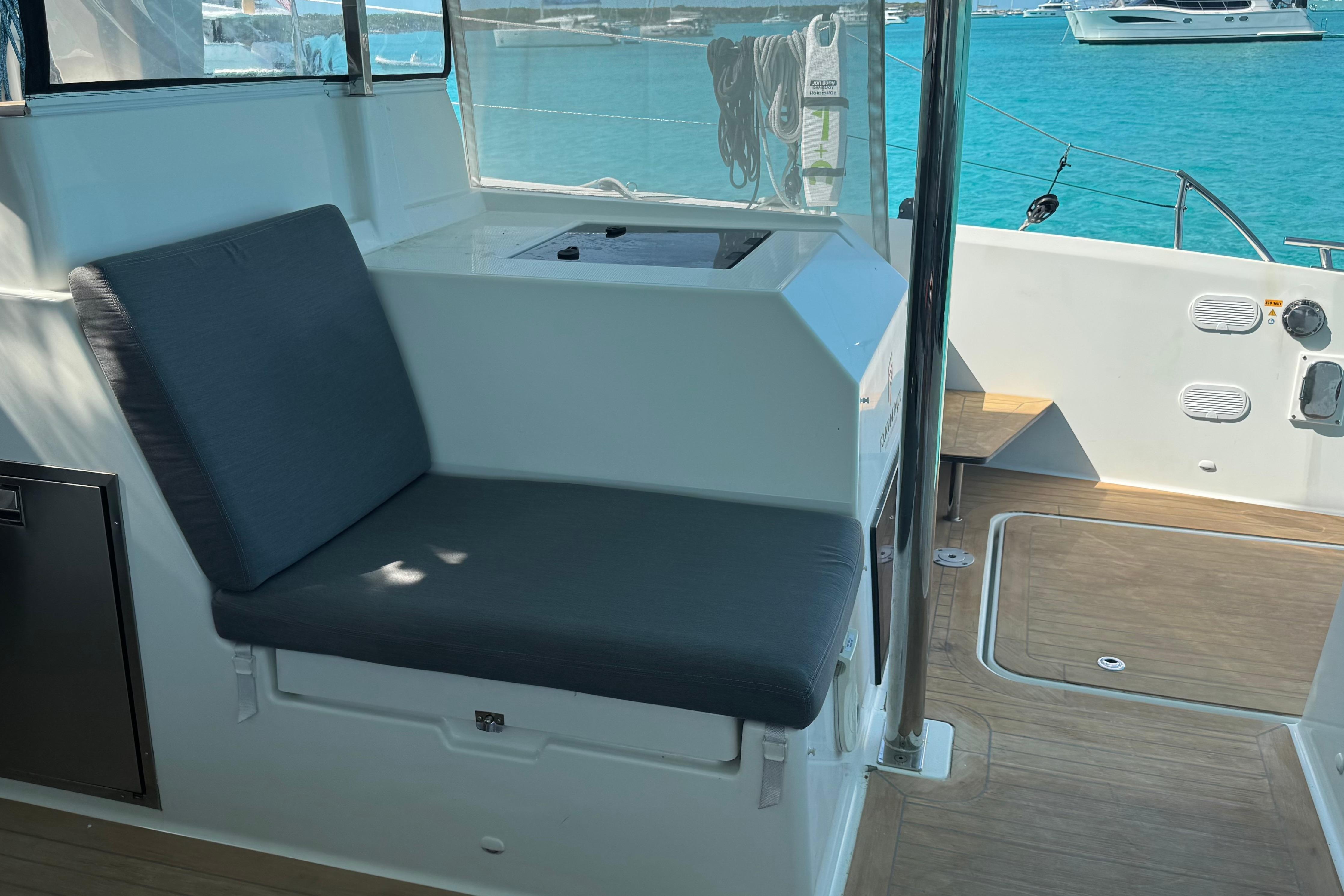 Interior view of 2020 Fountaine Pajot Saona 47 catamaran with seating and ocean backdrop.