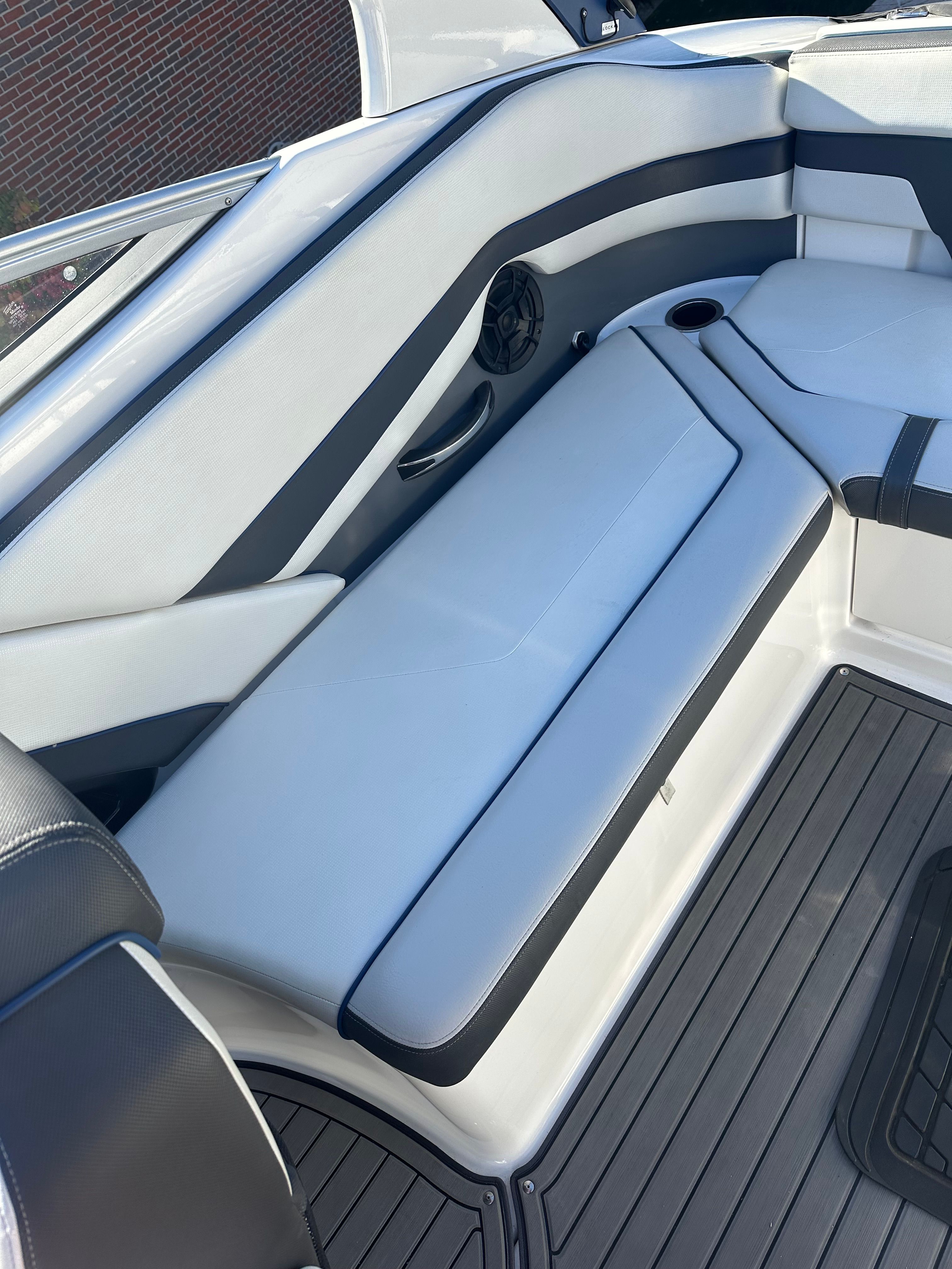 Interior of a 2018 Yamaha Boats 242 Limited S with gray and white upholstery.