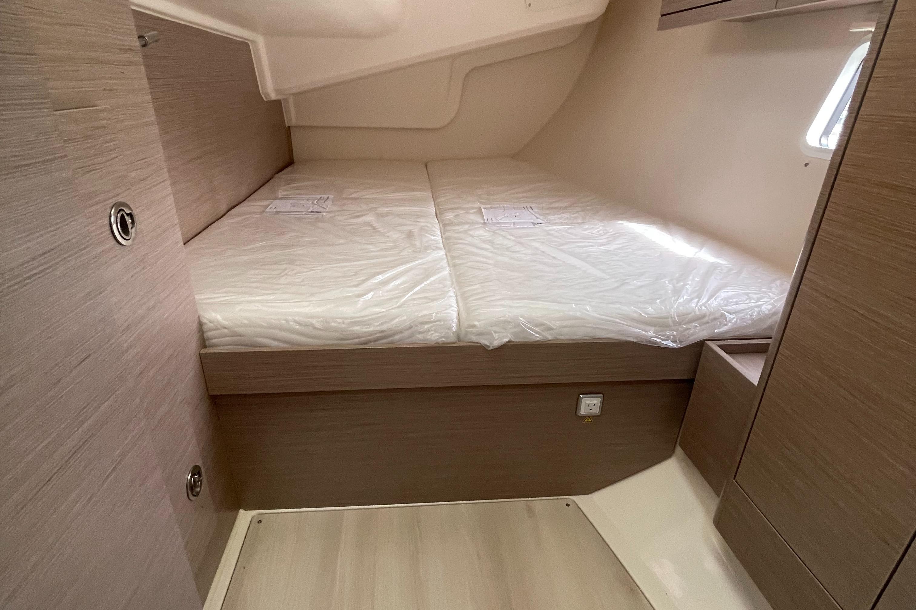 2021 Hanse 418 yacht cabin with twin beds, modern wood finish, and natural light.