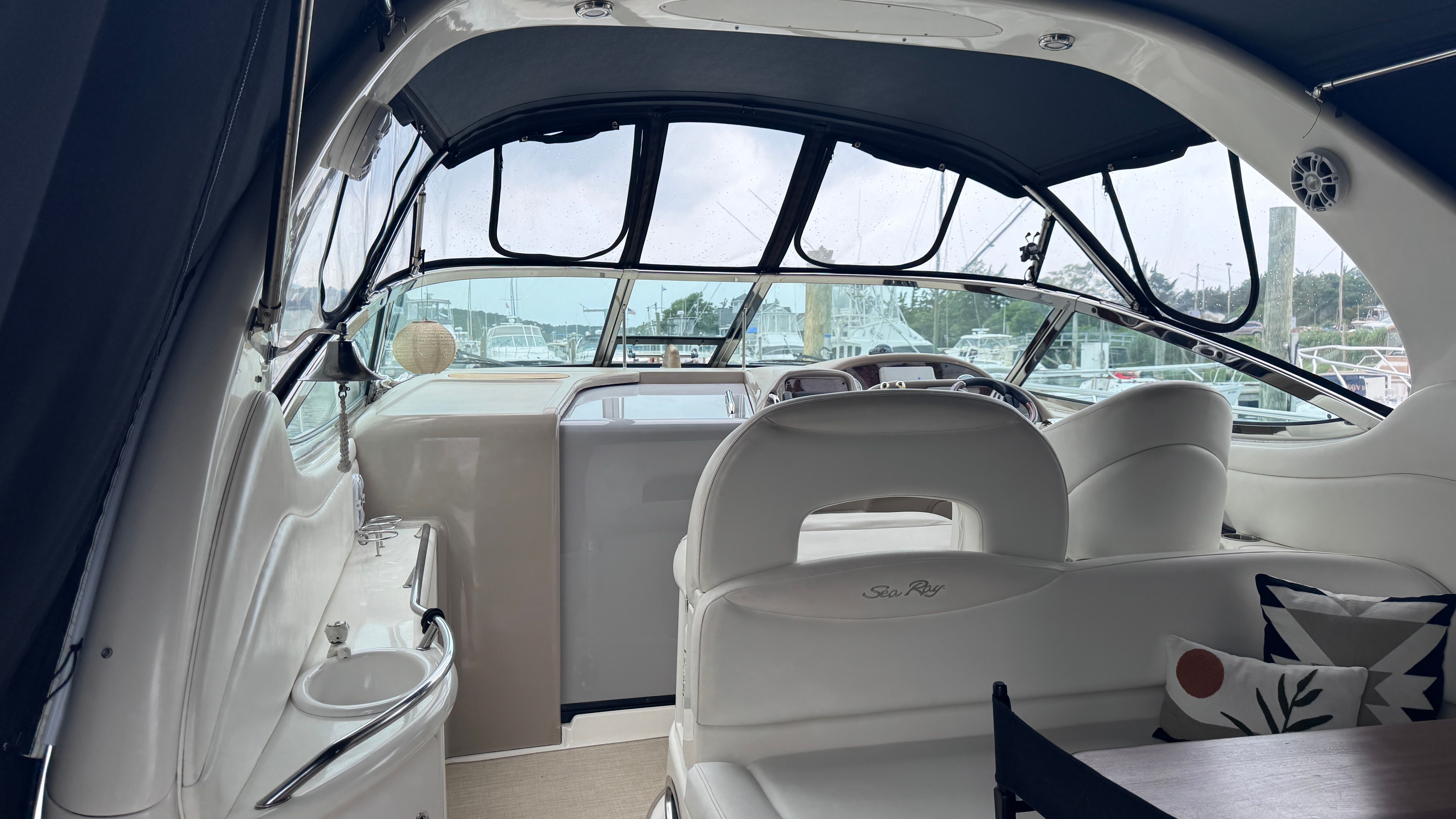 Interior of a 2003 Sea Ray 360 Sundancer with sleek white seating.