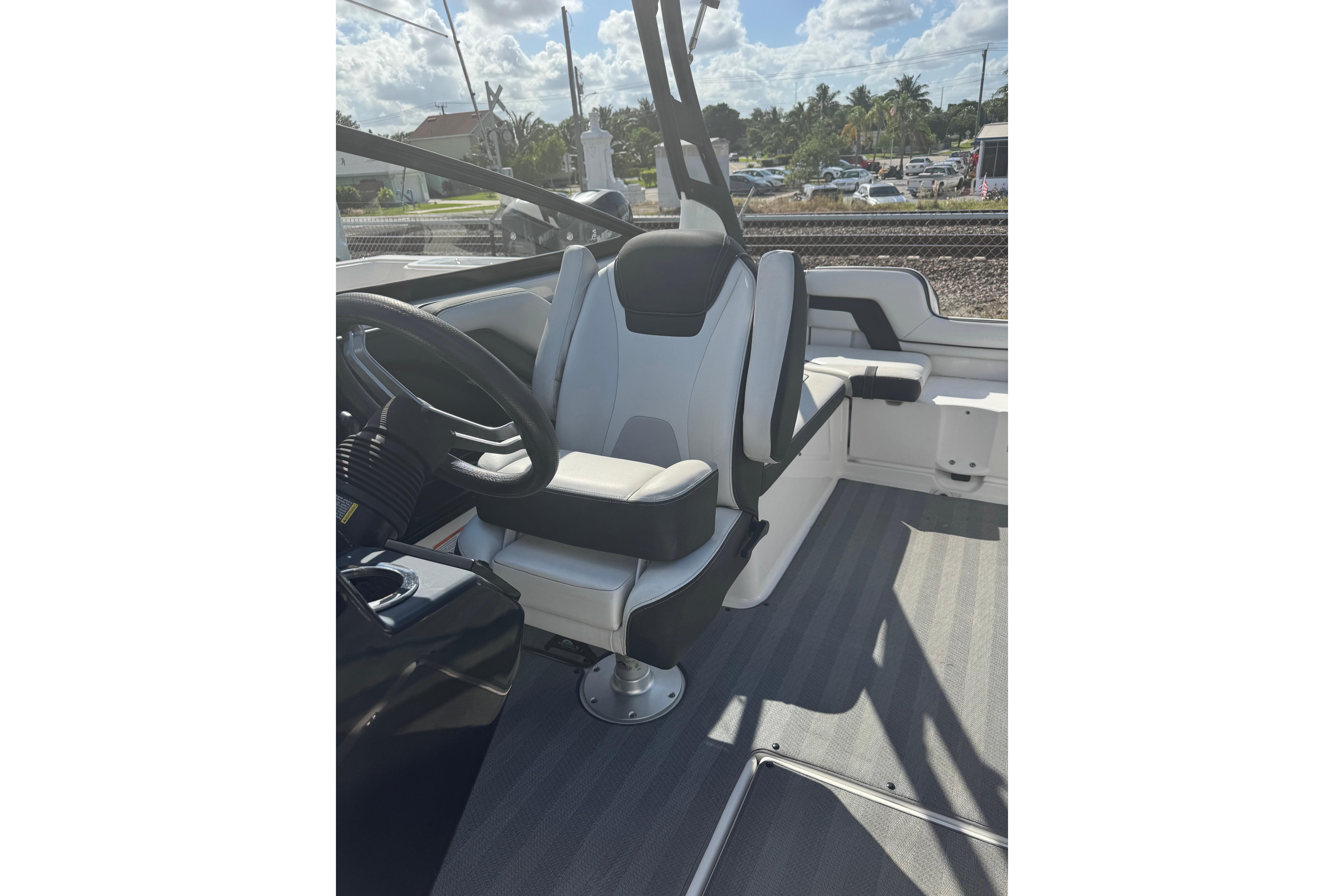 2019 Yamaha Boats 242 Limited S interior with steering wheel and seating.